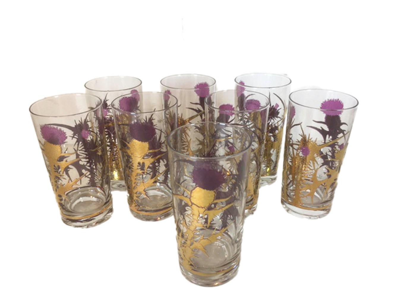 Nineteen piece vintage barware set designed by Gregory Duncan for West Virginia Glass and bearing his signature. Each piece decorated with thistle plants in raised translucent purple enamel on clear glass then covered in burnished 22-karat gold,