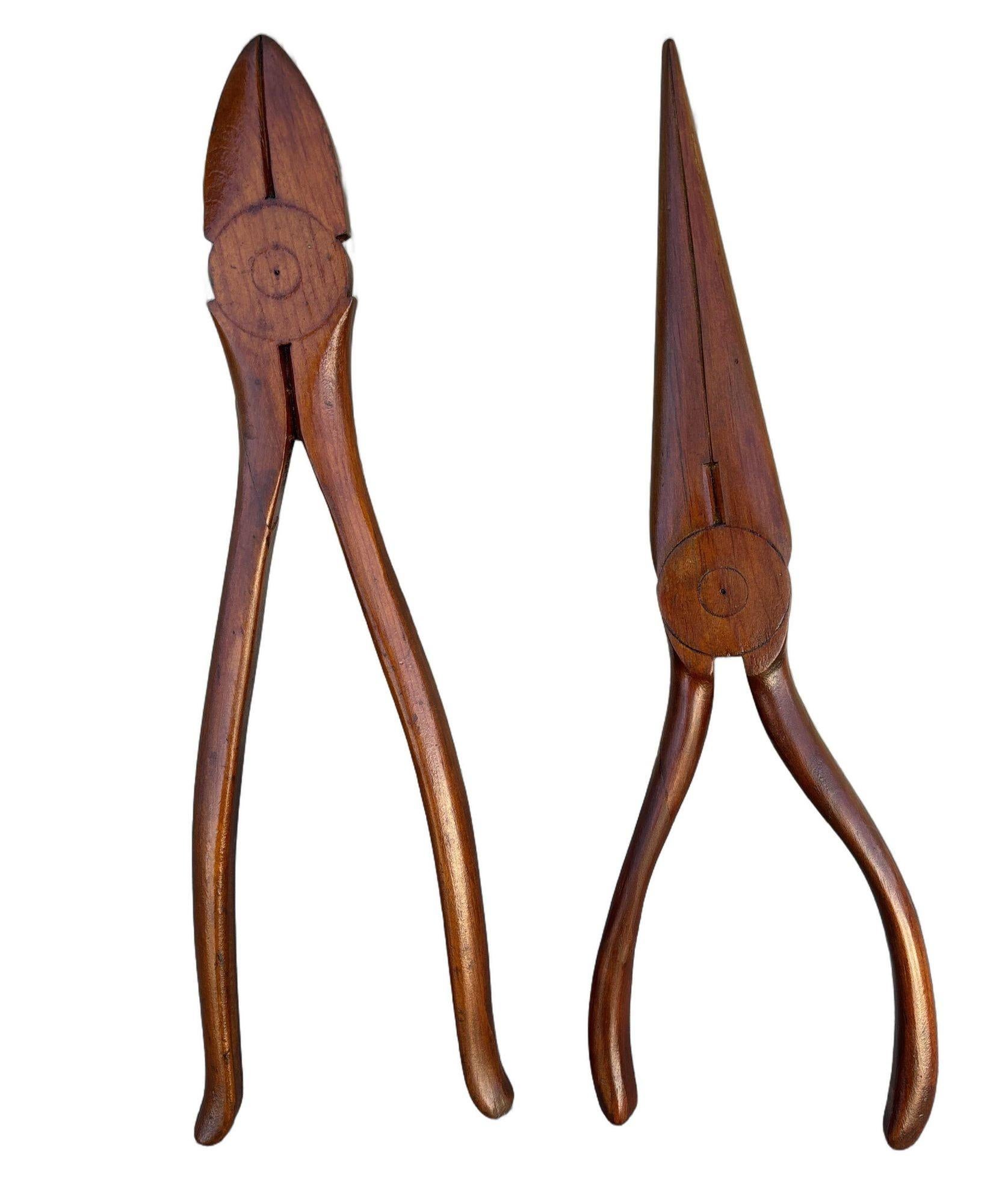 Behold a splendid pair of rustic wall art reminiscent of a bygone era. This charming artifact showcases two venerable hand tools: needlenose pliers and cutting pliers, rendered in a style that evokes the craftsmanship of a time long past. having