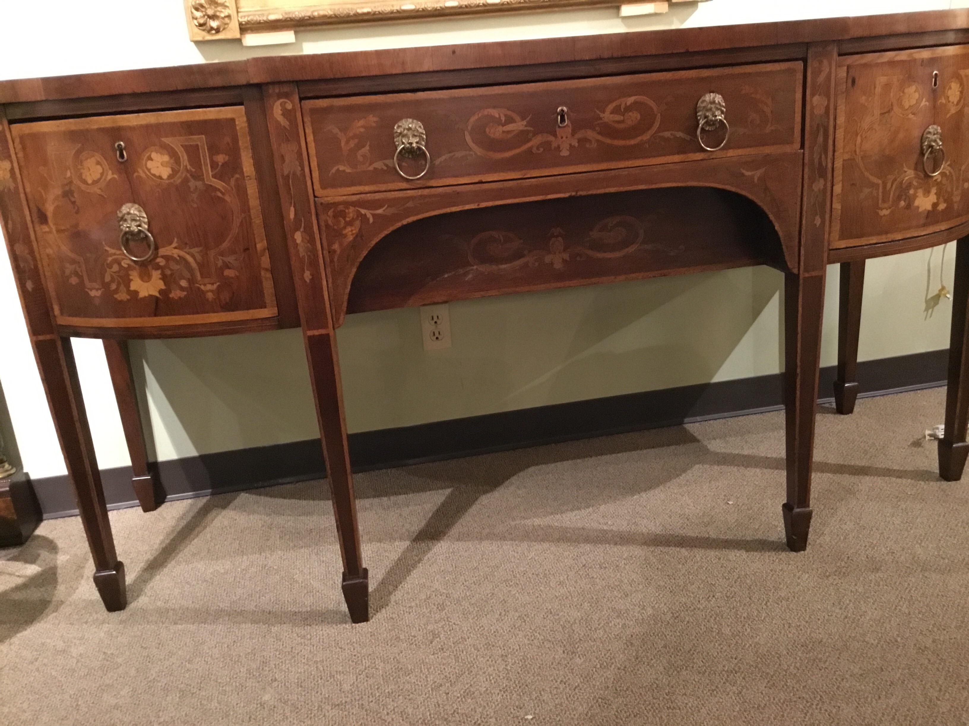 This is a 19th century server and buffet with original
patina having marquetry work in satinwood.
Straight tapered legs. Original brass hardware. Two
Drawers flanking each side. With one centre drawer.
All drawers slide easily. Structure is