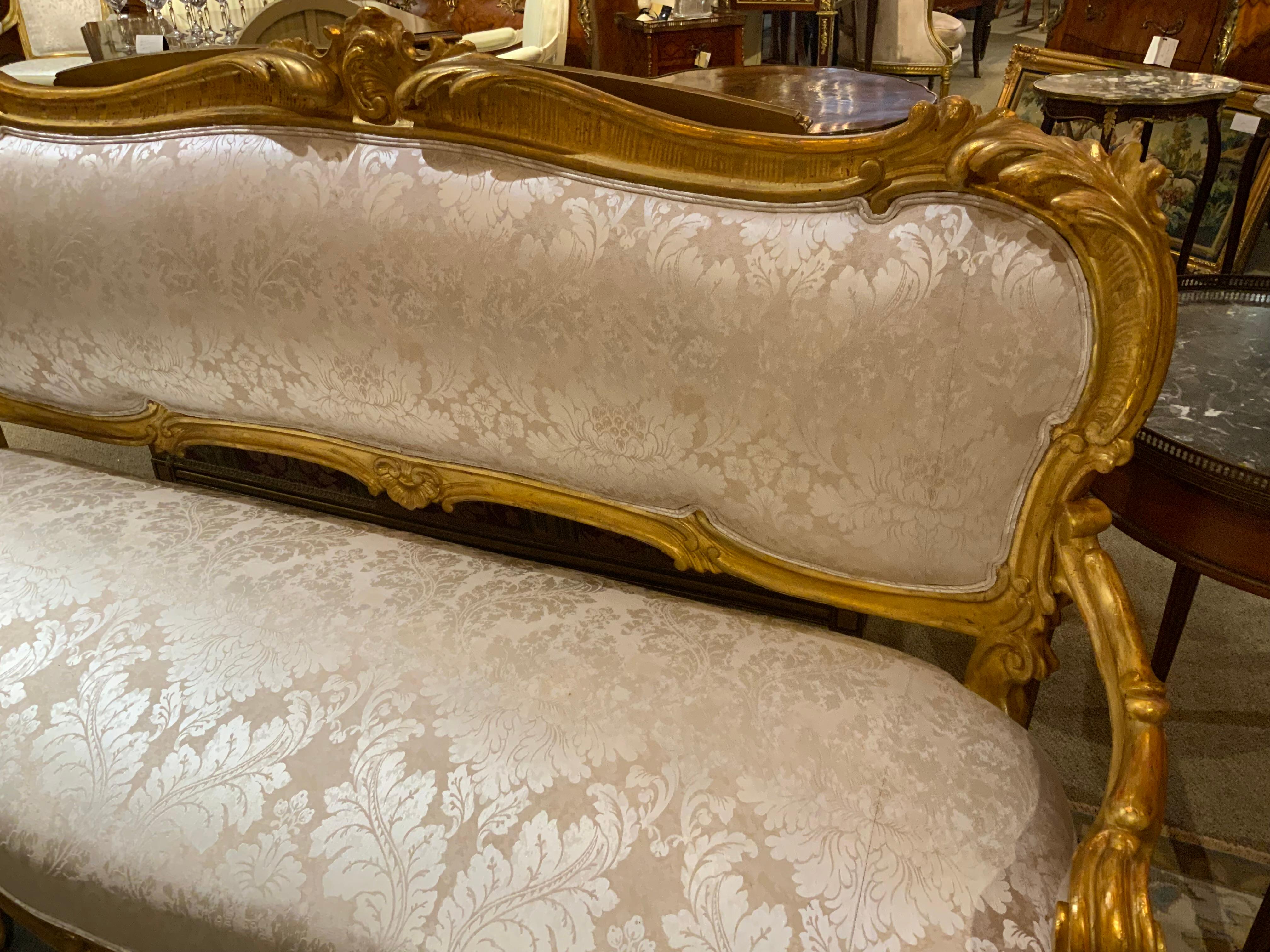 Fine carving with quality craftsmanship defines this excellent 
Settee. The louis XV style has a cabriole leg with elegant
Curved detail. A carved cartouche at the crest denotes
The  fine carving. It has been re upholstered in a cream 
And gold