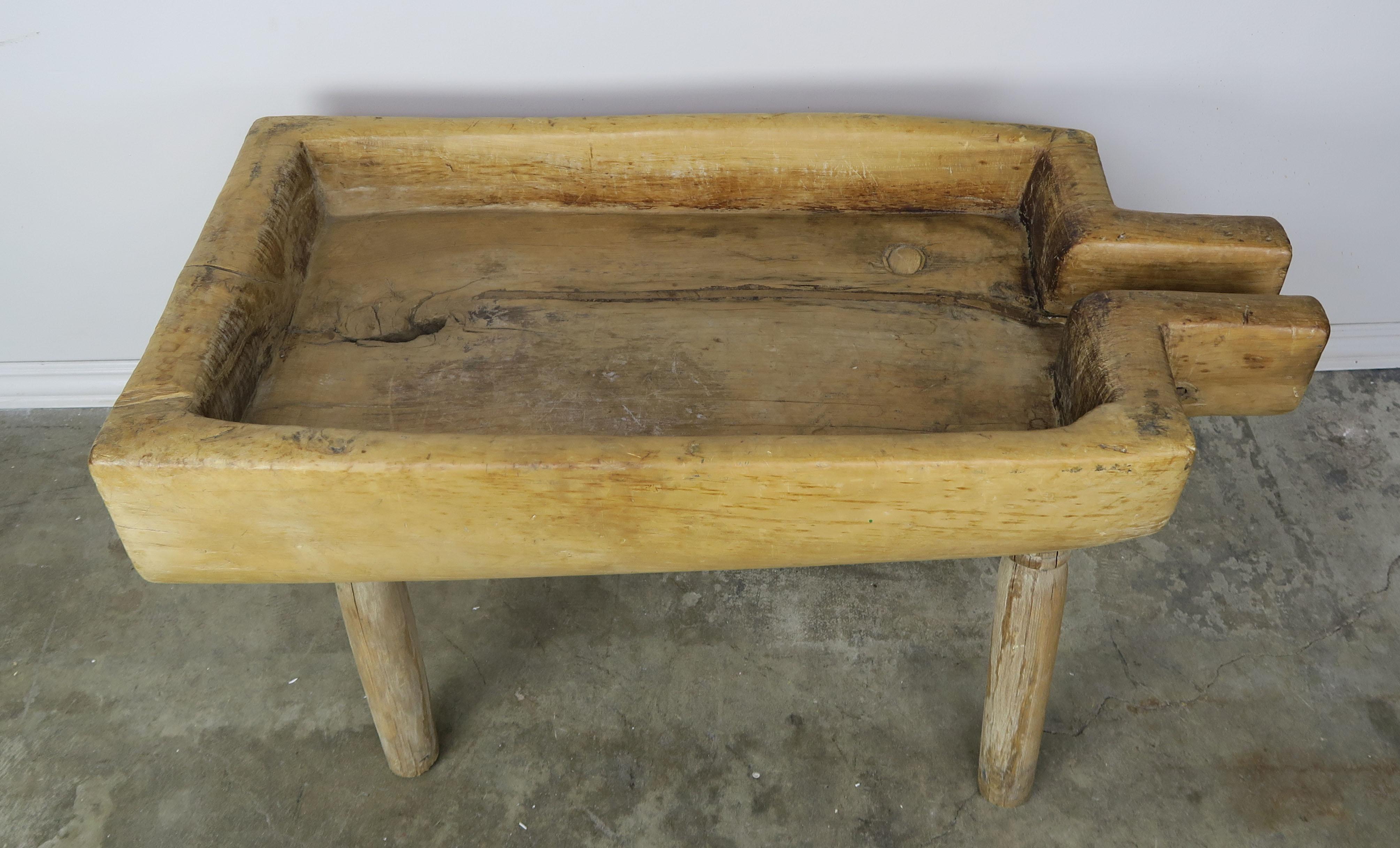 19th century wood trough with spout standing on four straight legs. Great accent table or storage for wood, etc.