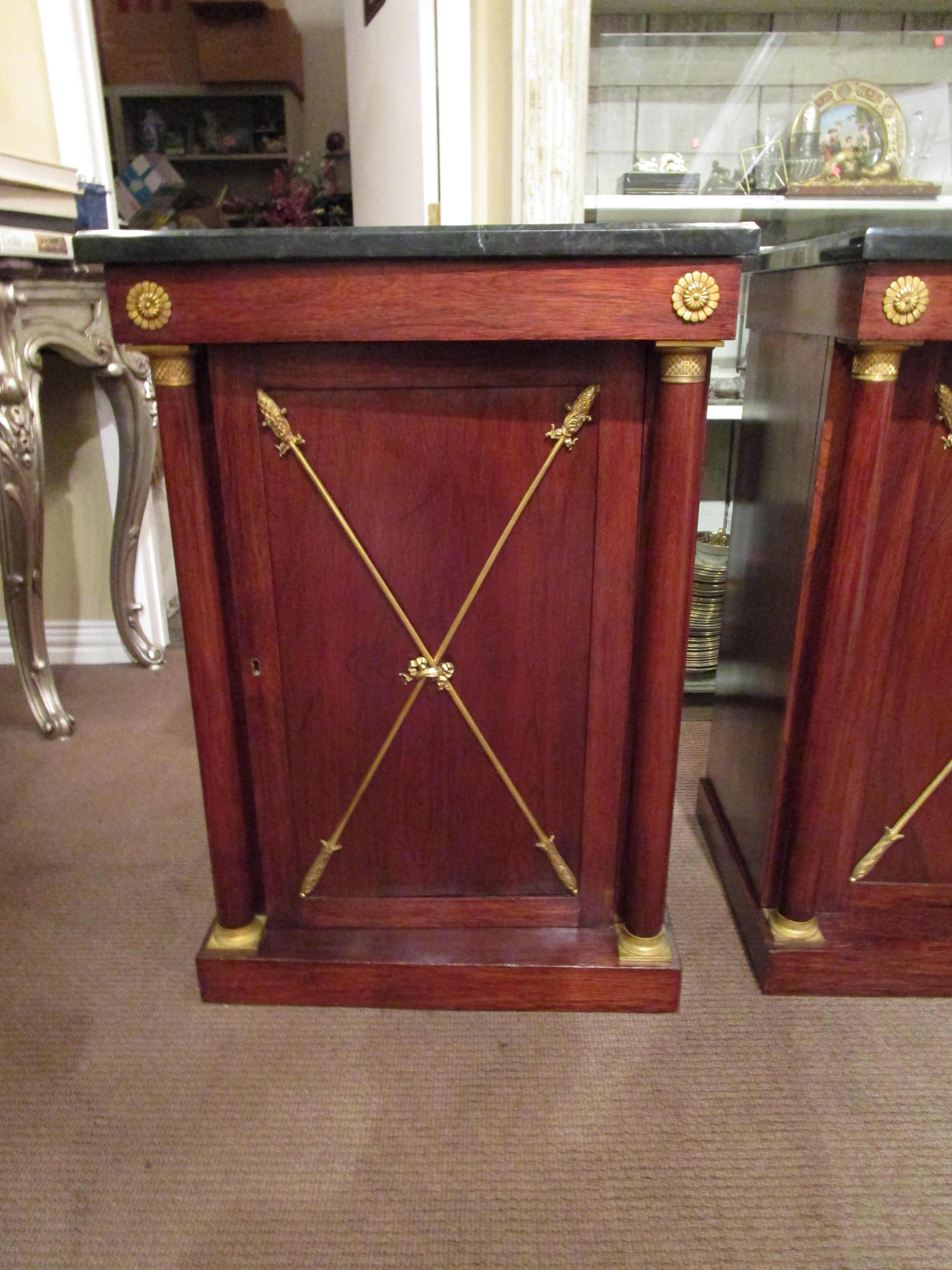 A very fine pair of 19th century Regency Rosewood and mahogany marble top cabinets with fine gilt bronze mounts. One shelf adjustable in each cabinet.