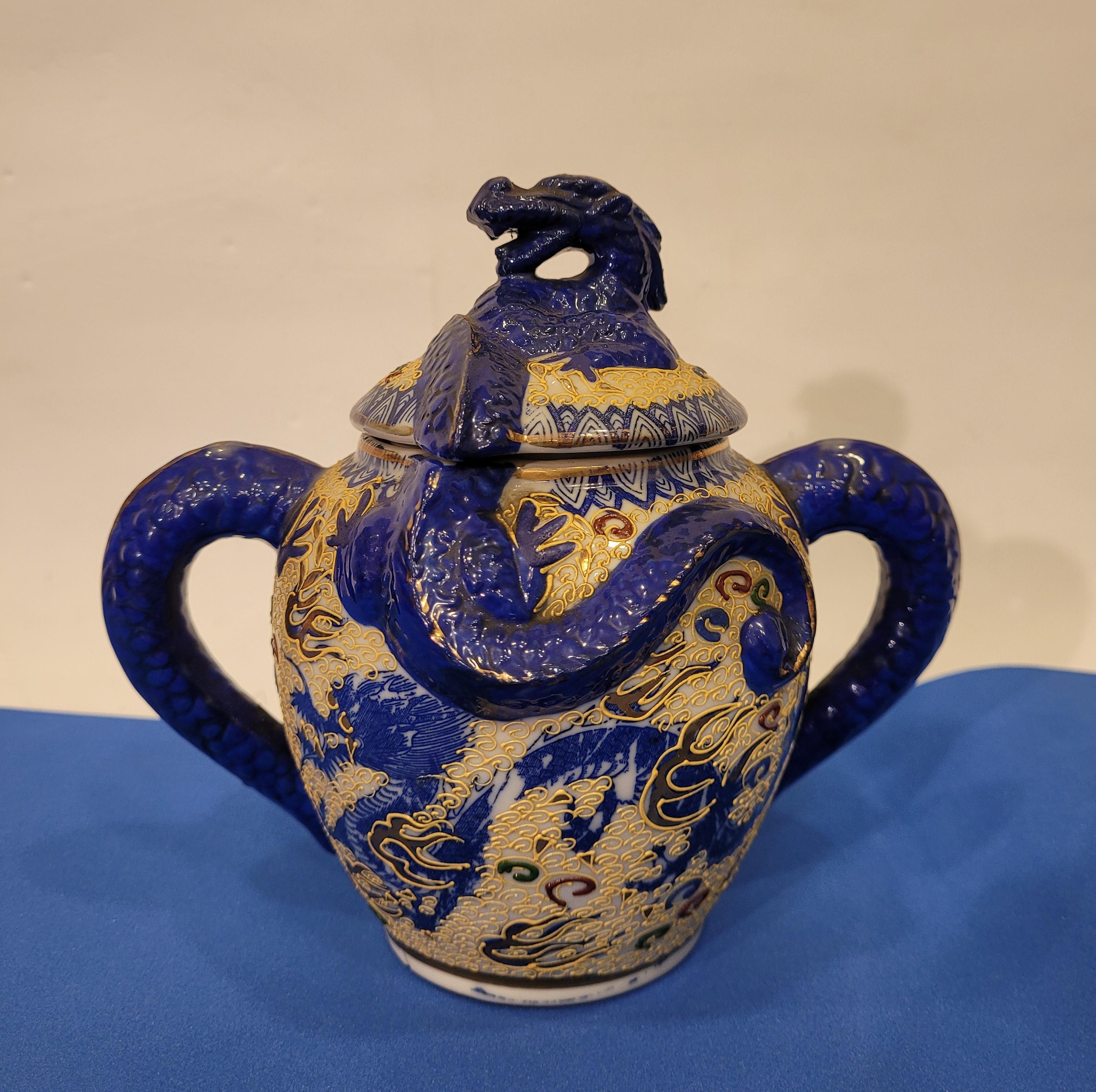 Gorgeous Satsuma porcelain set consisting of a teapot service, milk and sugar bowl, and five cup and saucer stations, all in a deep lapis lazuli blue. Satsuma porcelain is made throughout the Meiji Period between 1868 and 1912 in Japan.

It is an