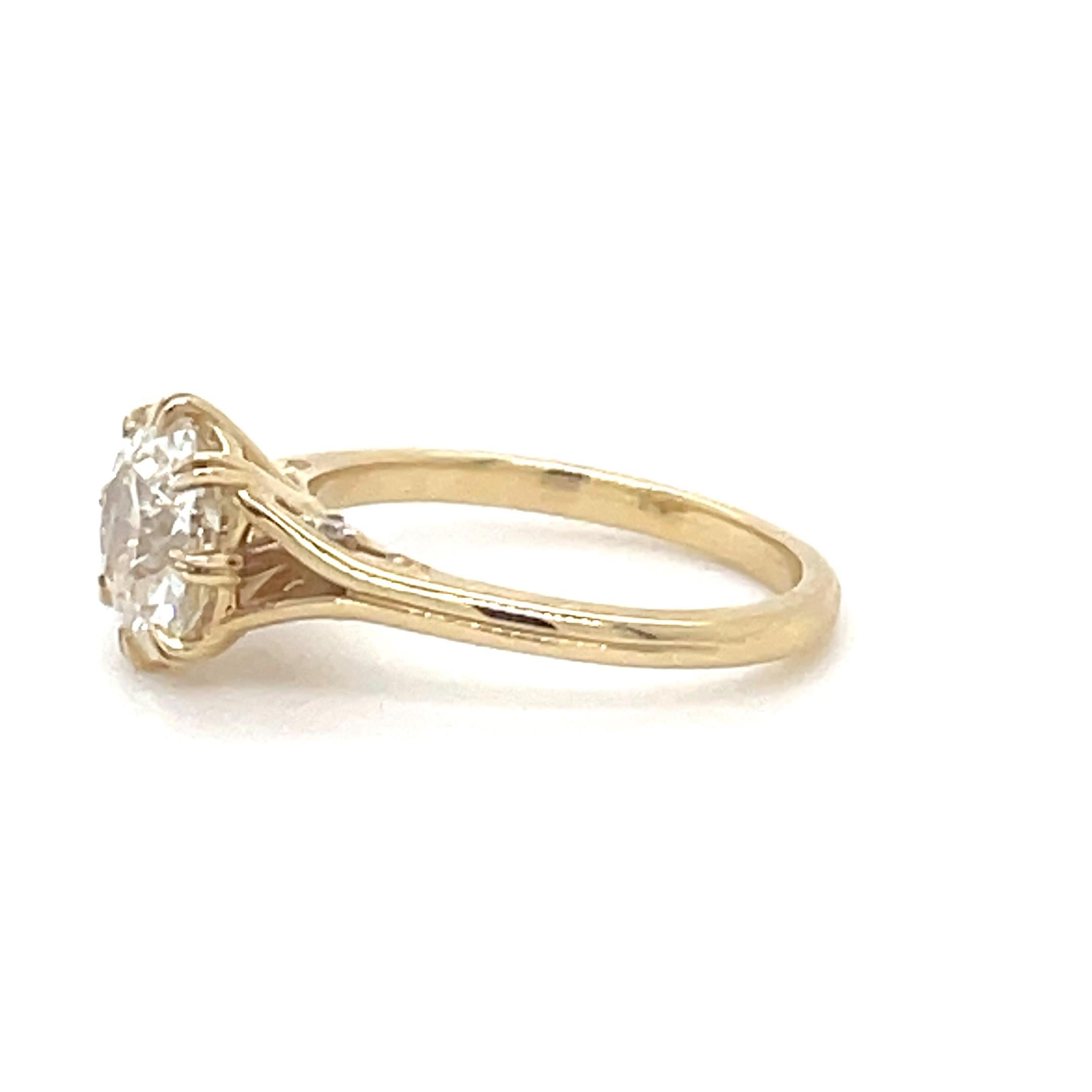 This beautifully classic ring, boasts a 1.90 carat antique cushion cut diamond surrounded by elegant claw prongs, atop a gallery with four round brilliant cut diamonds and circular detailing. Perfect for the heirloom seeker! 

Metal: 18 Karat