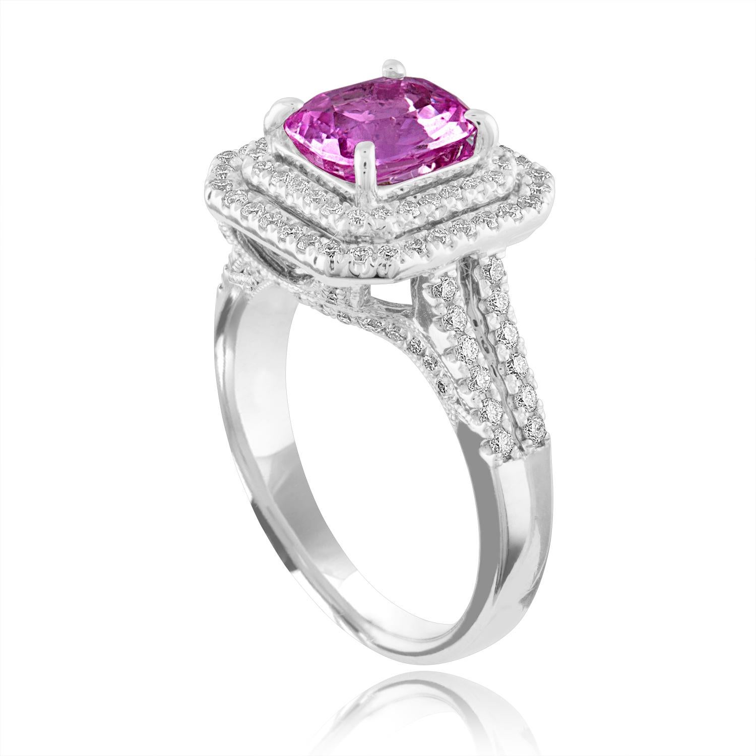 Exquisite Sapphire Surrounded by Double Diamond Halo
The ring is 18K White Gold
The Cushion Cut Sapphire is Pink 1.90 Carats
The Sapphire is Heated
There are 0.74 Carats in Diamonds F/G VS/SI
The ring is a size 6.50, sizable.
The ring weighs 7.6