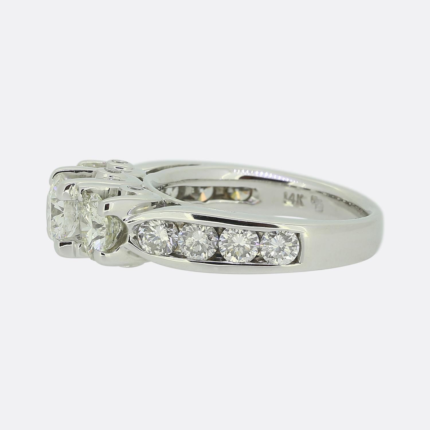 Here we have a wonderful three-stone diamond ring. A trio of round brilliant cut diamonds sit proud atop the centre of the face; the largest of which is slightly risen at the centre. The expertly crafted open claw settings allow for the full shape