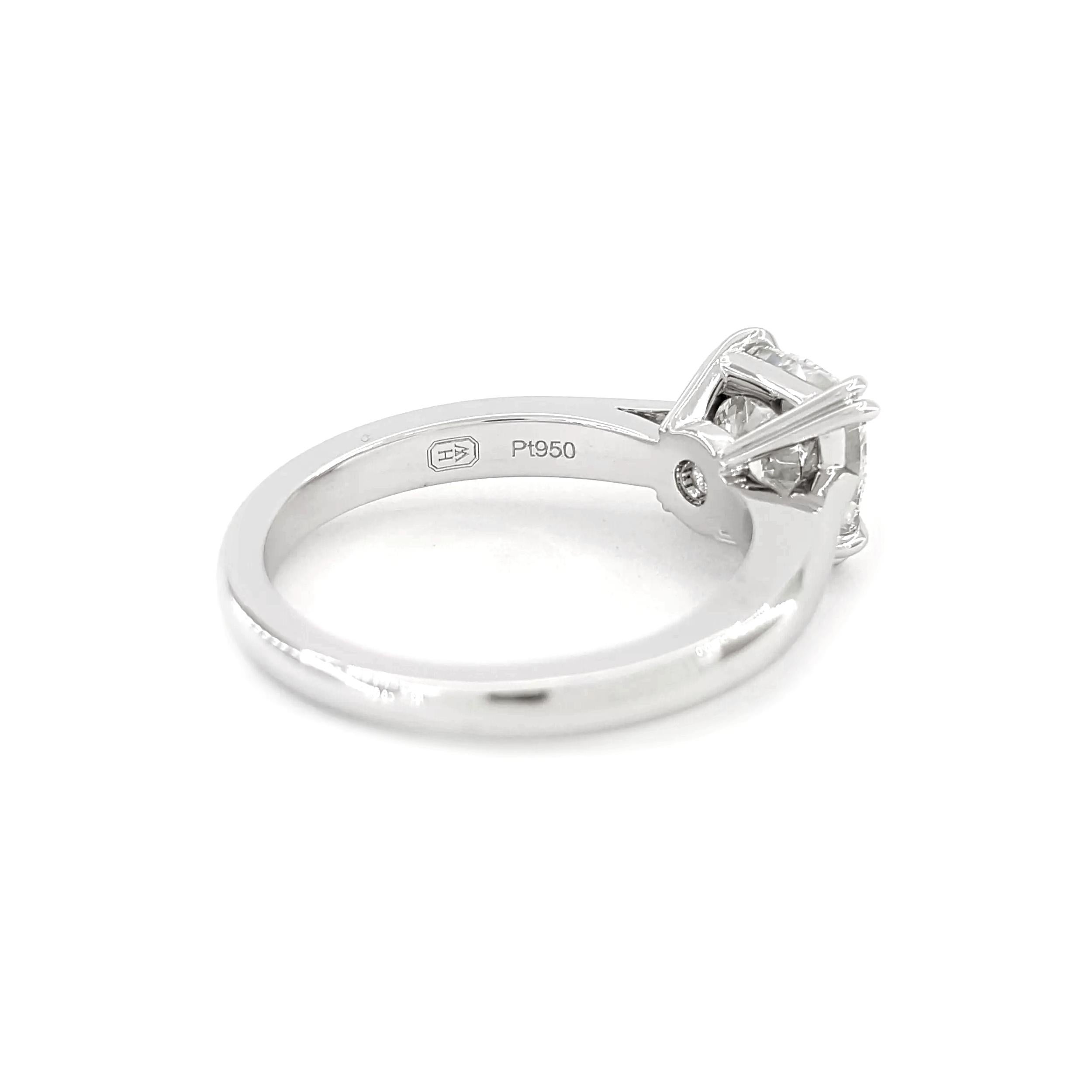 This stunning Harry Winston Platinum Engagement Ring features a magnificent 1.90-carat natural cushion-cut diamond, meticulously crafted to showcase its brilliance and elegance. Graded E in color and VVS1 in clarity, the diamond boasts excellent