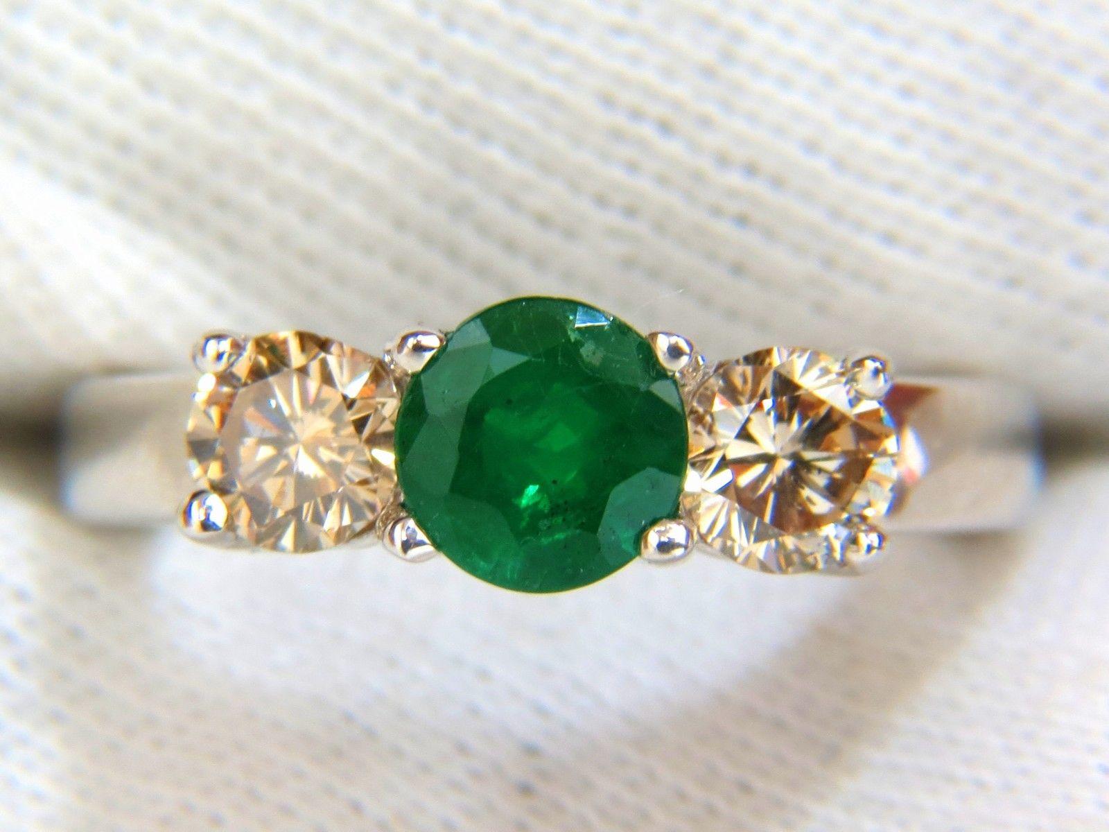.90ct. Natural Emerald diamond ring

6.3mm Diameter

Transparent & Clean clarity.

Vibrant Green tone

Fully faceted round cut brilliant

  

Side Round, full cut diamonds:

1.00ct. 

Fancy Natural Light Brown

Vs-2 Clarity.

14kt. white gold.

6.5