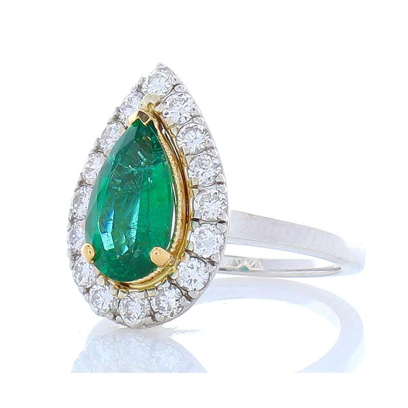 This is a 1.90 carat pear-shaped emerald sourced in Zambia. Its color is deep grass green; its luster is excellent. The shape is an splendid raindrop. It is prong set in yellow gold, measuring 11.10x6.6mm A total of 16 glittering round brilliant cut