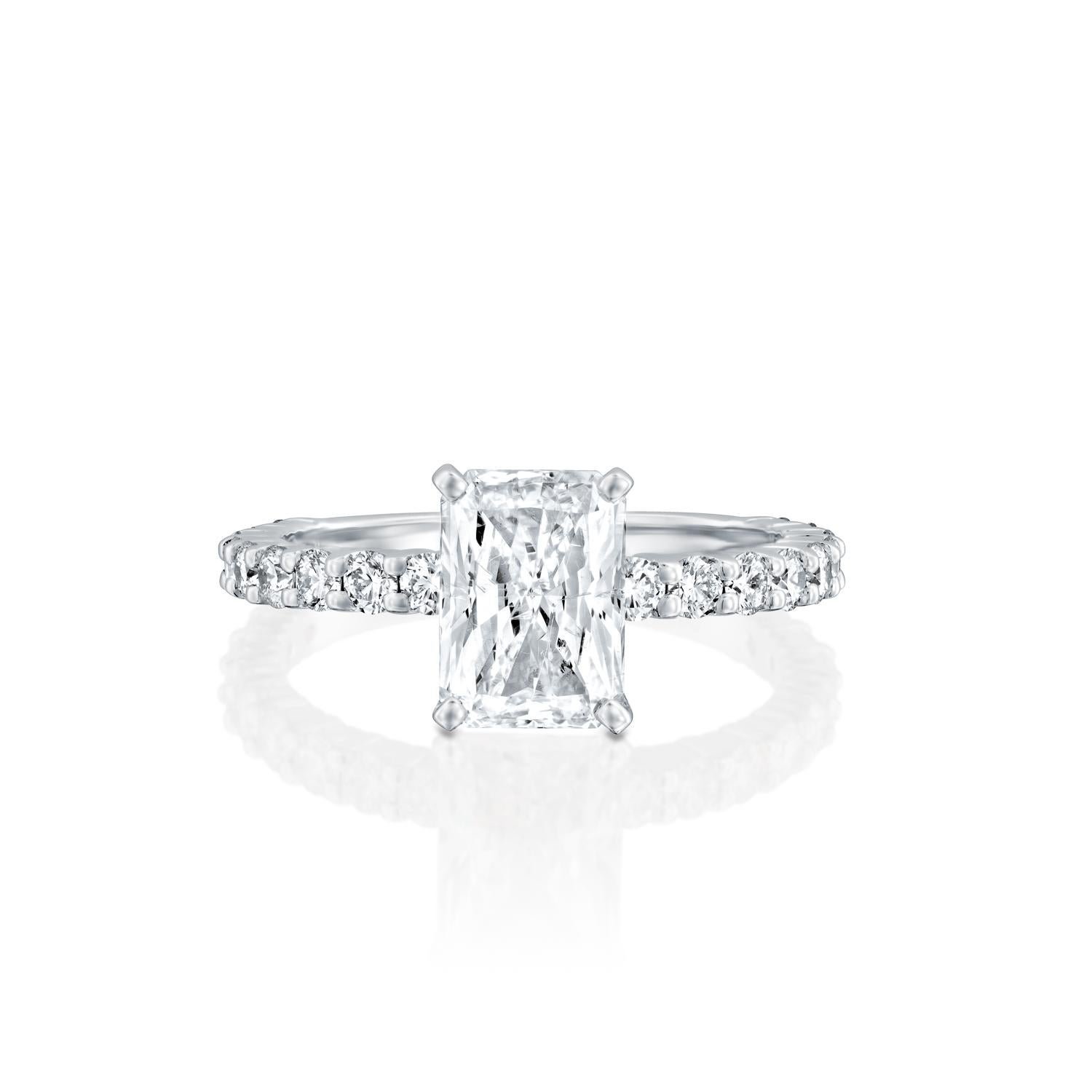 This impressive ring features a solitaire GIA certified diamond. Center stone is 100% eye clean natural, radiant shaped 1 carat diamond of F-G color and VS2-SI1 clarity and it is surrounded by smaller natural round diamonds of 0.90 total carat