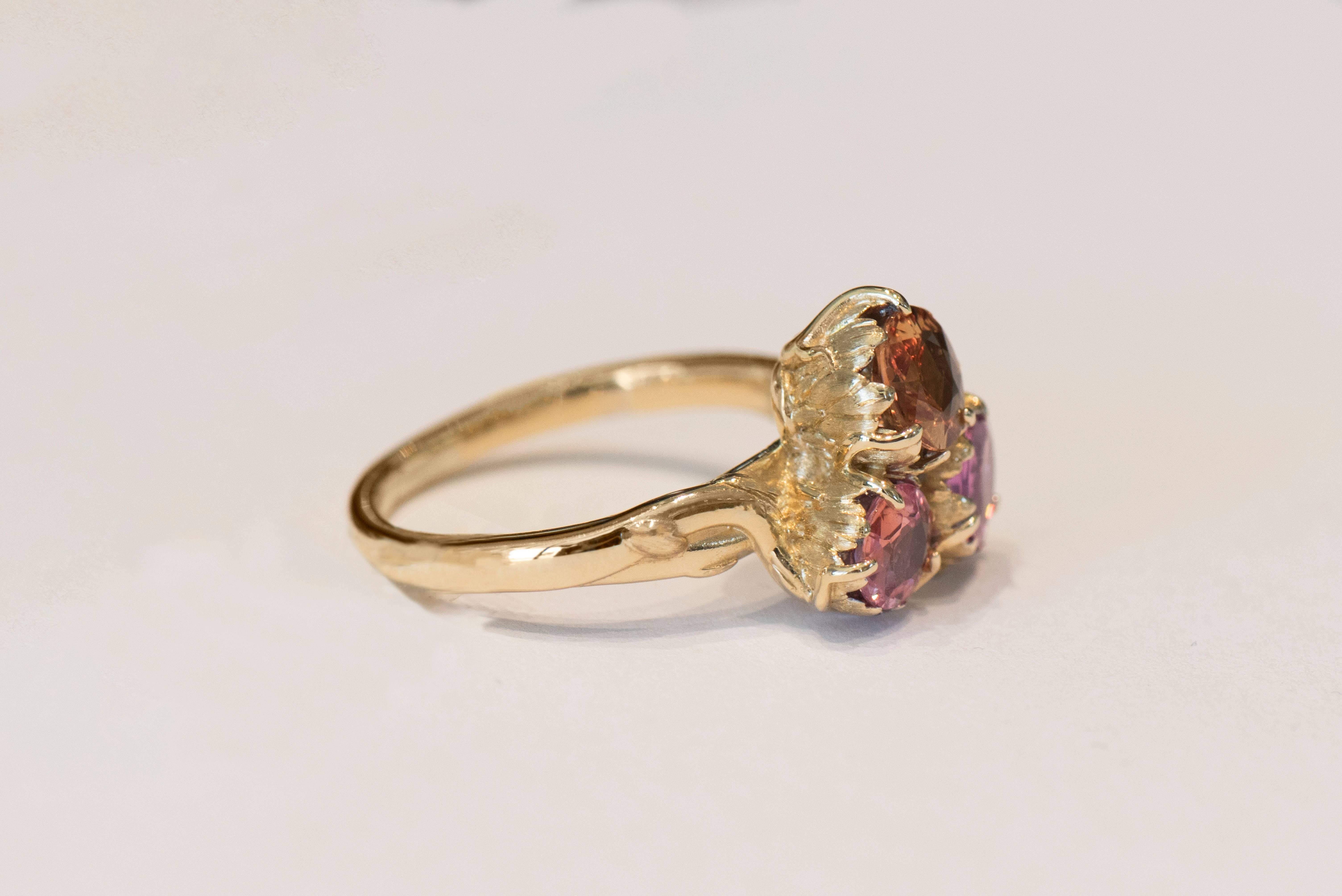 1.90 Carat TW Fancy Sapphire Trio with Amber, Pink, and Padparadscha Colors

Inspired by nature, with hand carved flowing vines and flower petals, this stunning 14 karat yellow gold ring is truly unique! Amber, pink, and padparadscha colored