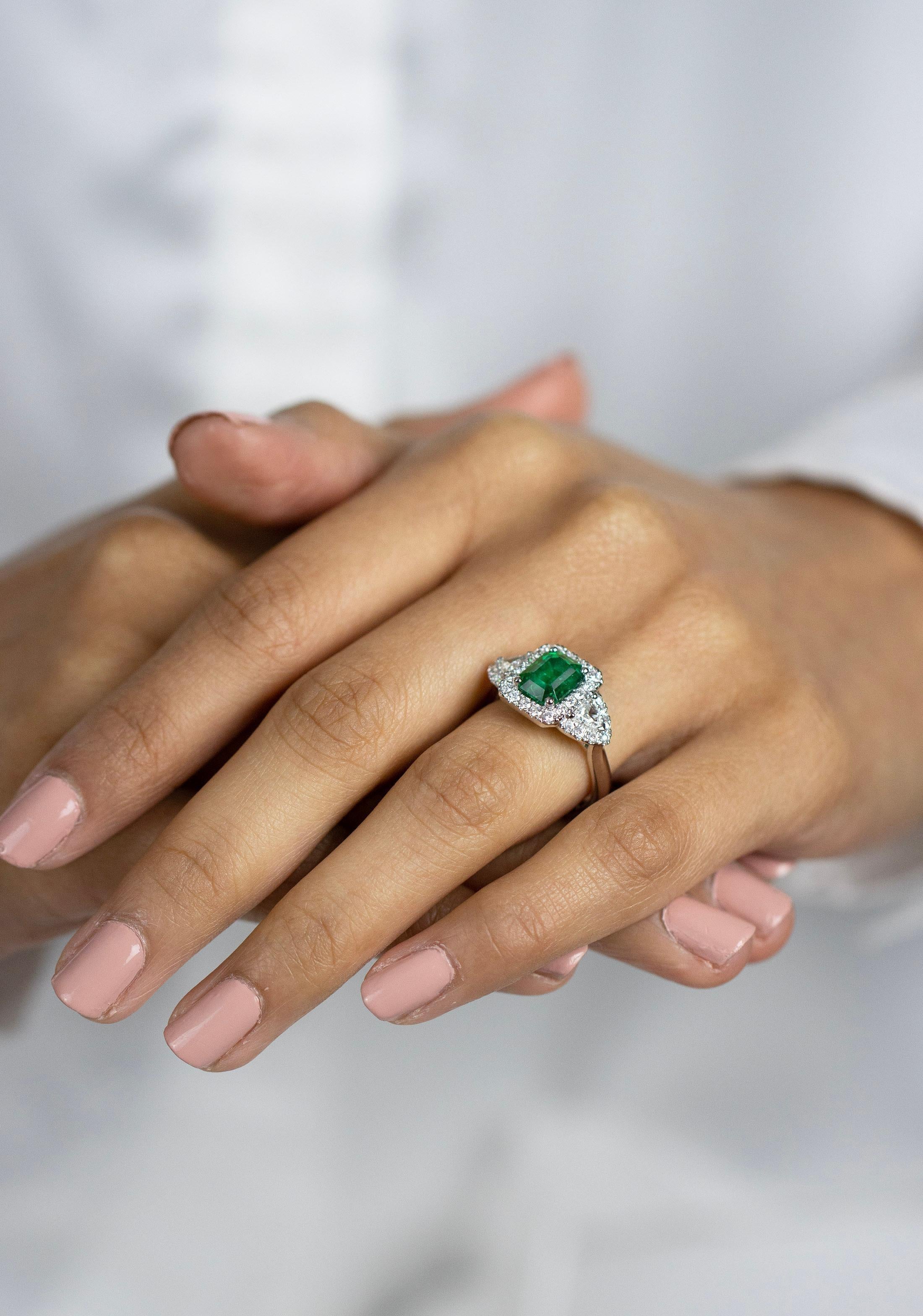 Contemporary 1.90 Carats Emerald Cut Green Emerald & Diamond Three Stone Halo Engagement Ring For Sale