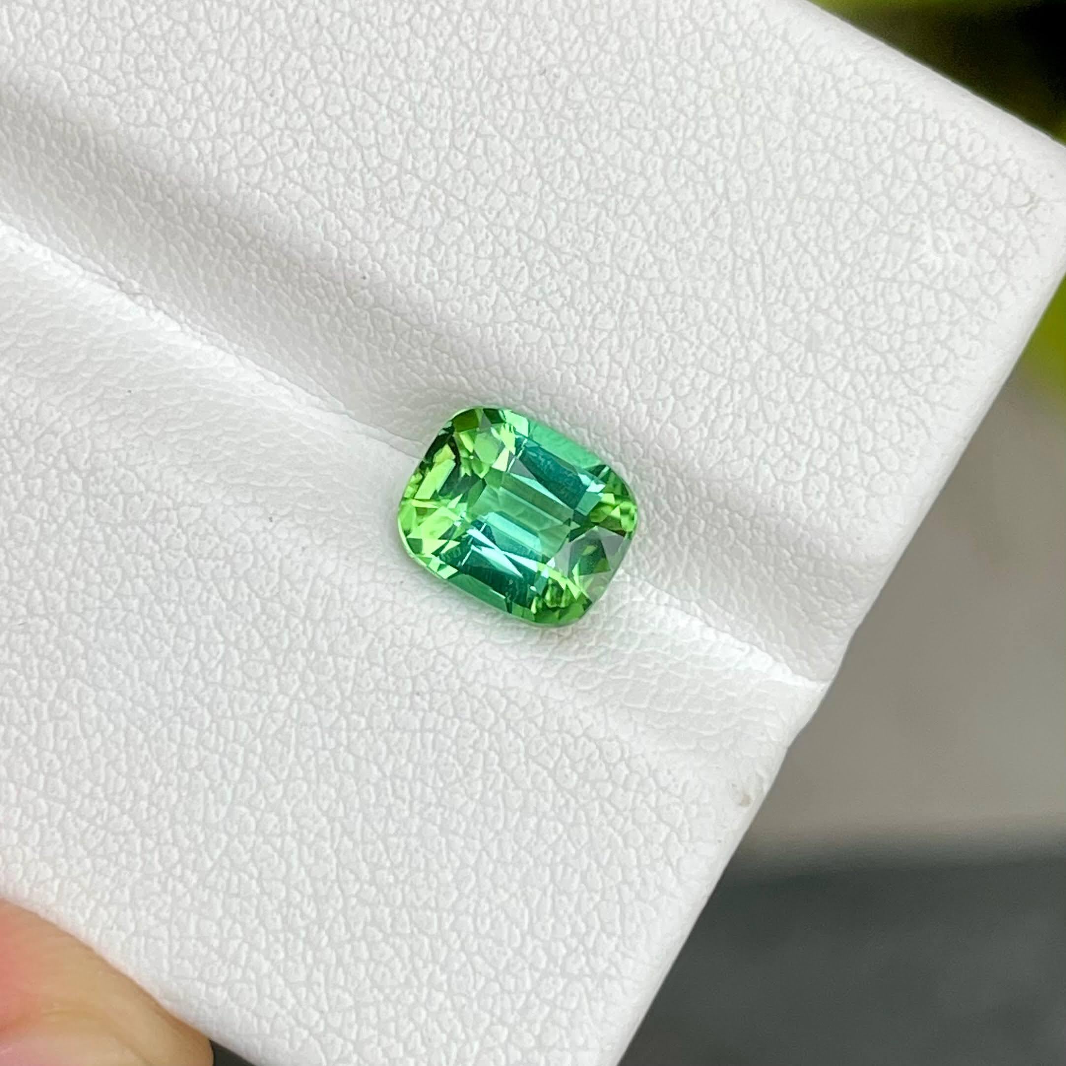 Weight 1.90 carats 
Dimensions 7.9x6.5x5.1 mm
Clarity VVS
Origin Afghanistan
Treatment None
Shape Cushion
Cut Step Cushion




In a breathtaking display of nature's artistry, a 1.90-carat Greenish Blue Tourmaline takes center stage, showcasing a
