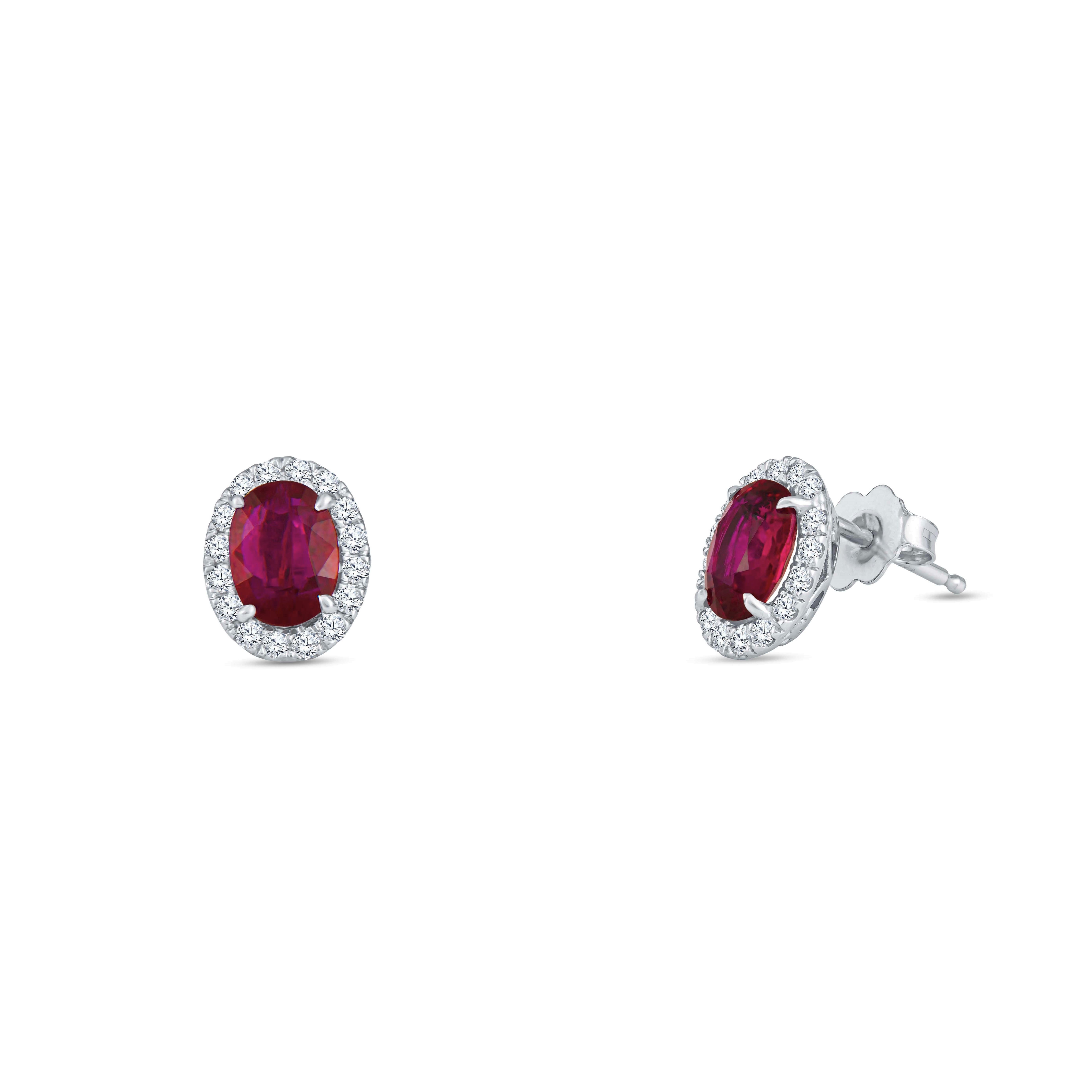 Stunning 0.32 carats round brilliant cut diamond halo stud earrings that beautifully surround two perfectly matched natural oval rubies with 1.90 carats total weight. 

Diamond quality: G-H color, VS2-SI1 clarity