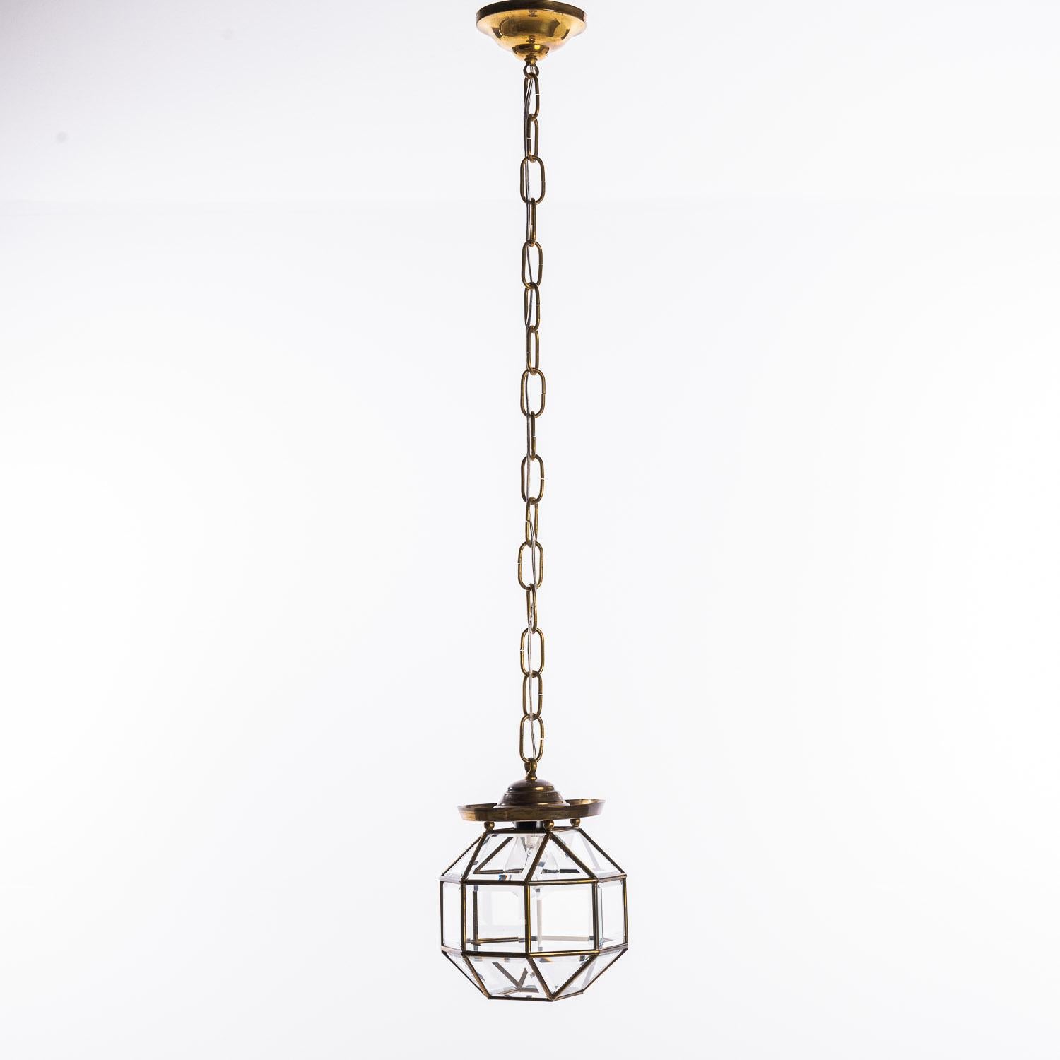 Amsterdam School long chain lantern from manufactured between 1900 -1920. Consists of a copper frame with facet cut glass windows. The lamp is still in good condition considering its age. One piece has a dent in the top. The glass is in very good