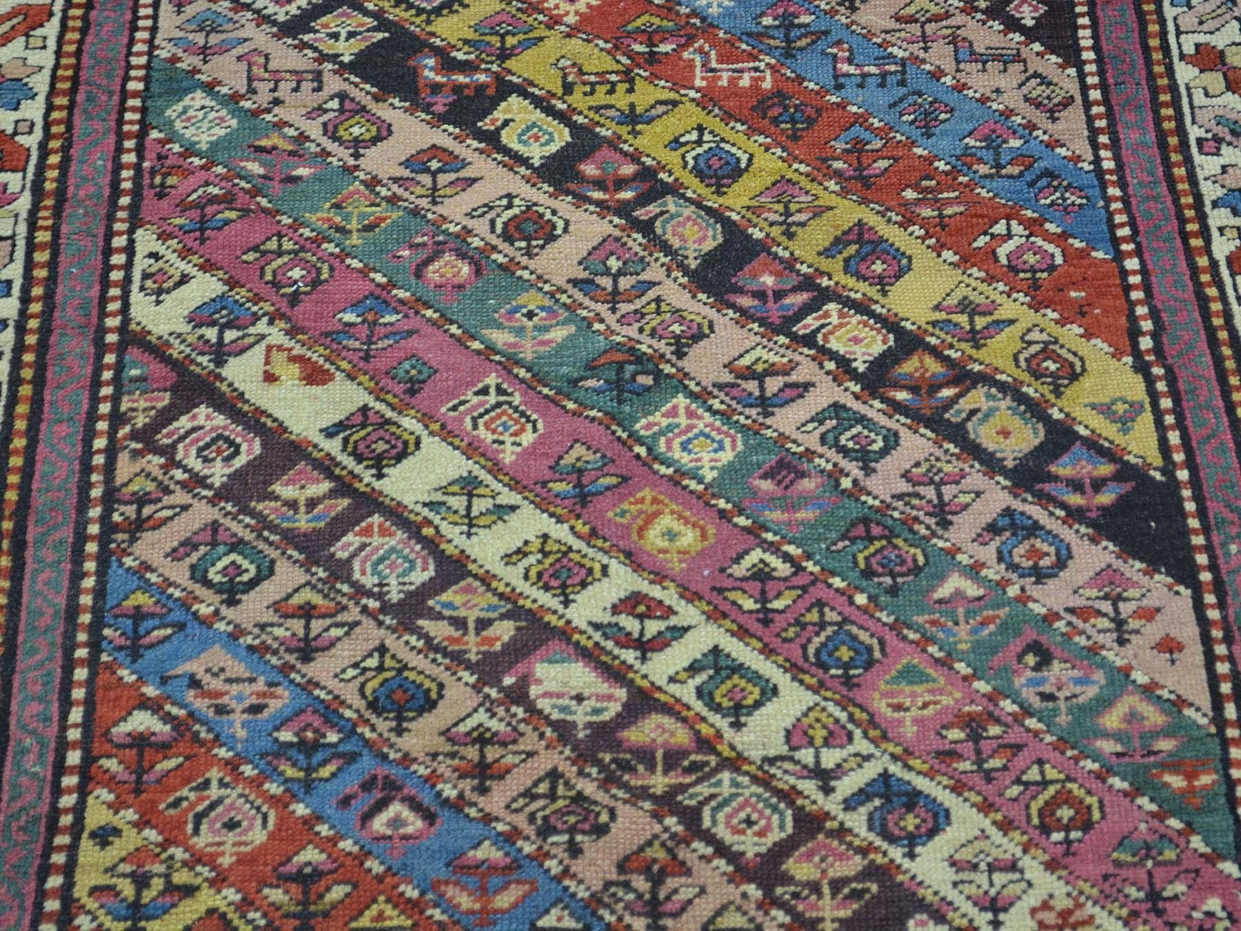 This is a genuine hand knotted Caucasian rug. It is not hand-tufted or machine made. Our entire inventory is made of either hand knotted or handwoven rugs. 

Renovate your home style with this charming antique carpet. This handcrafted Caucasian