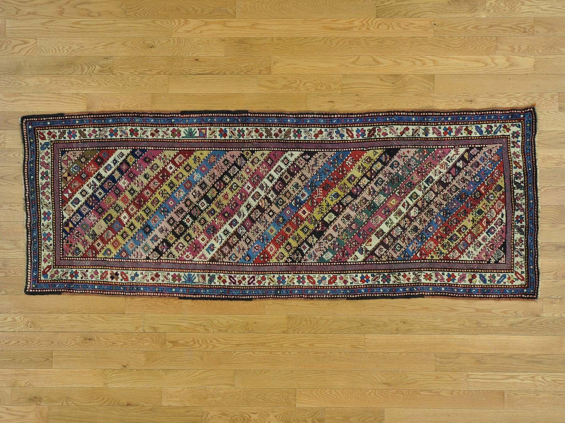 This is a genuine hand knotted Caucasian rug. It is not hand-tufted or machine made. Our entire inventory is made of either hand knotted or handwoven rugs. 

Renovate your home style with this charming antique carpet. This handcrafted Caucasian