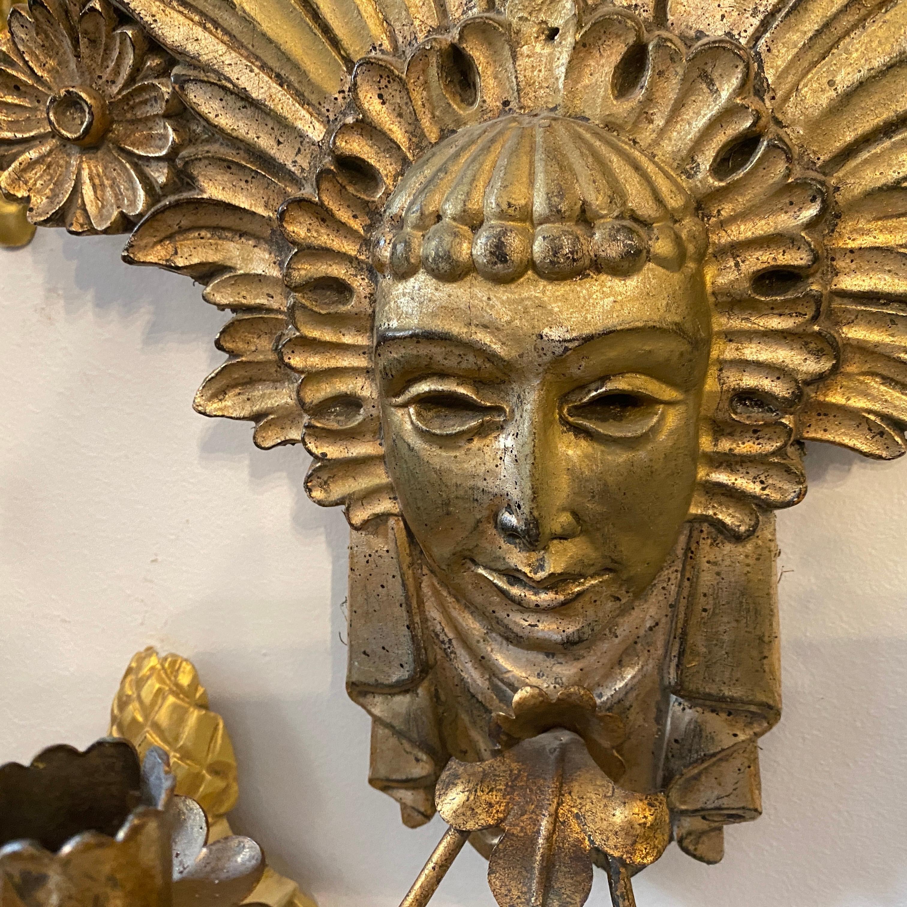It's a wall candelabra made in Italy in 1900, old gilded wood and iron are in good conditions considering use and age. It can be easily electrified.