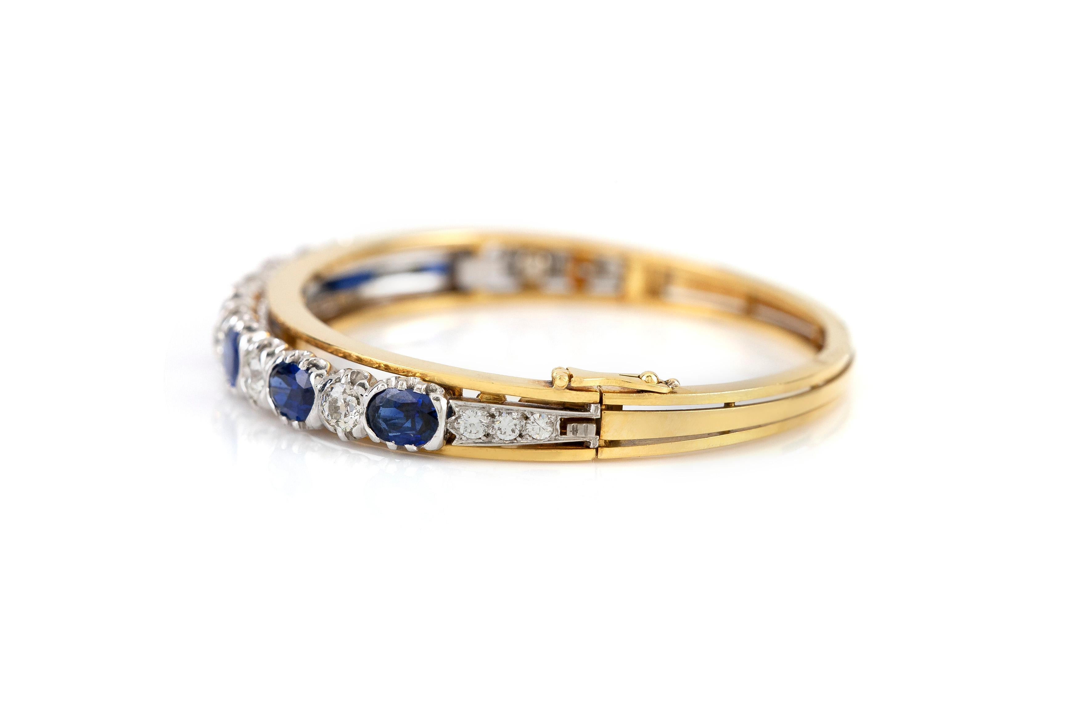 The bangle is finely crafted in 18k yellow gold with sapphire weighing approximately total of 5.00 carat and diamonds weighing approximately total of 2.50 cara.