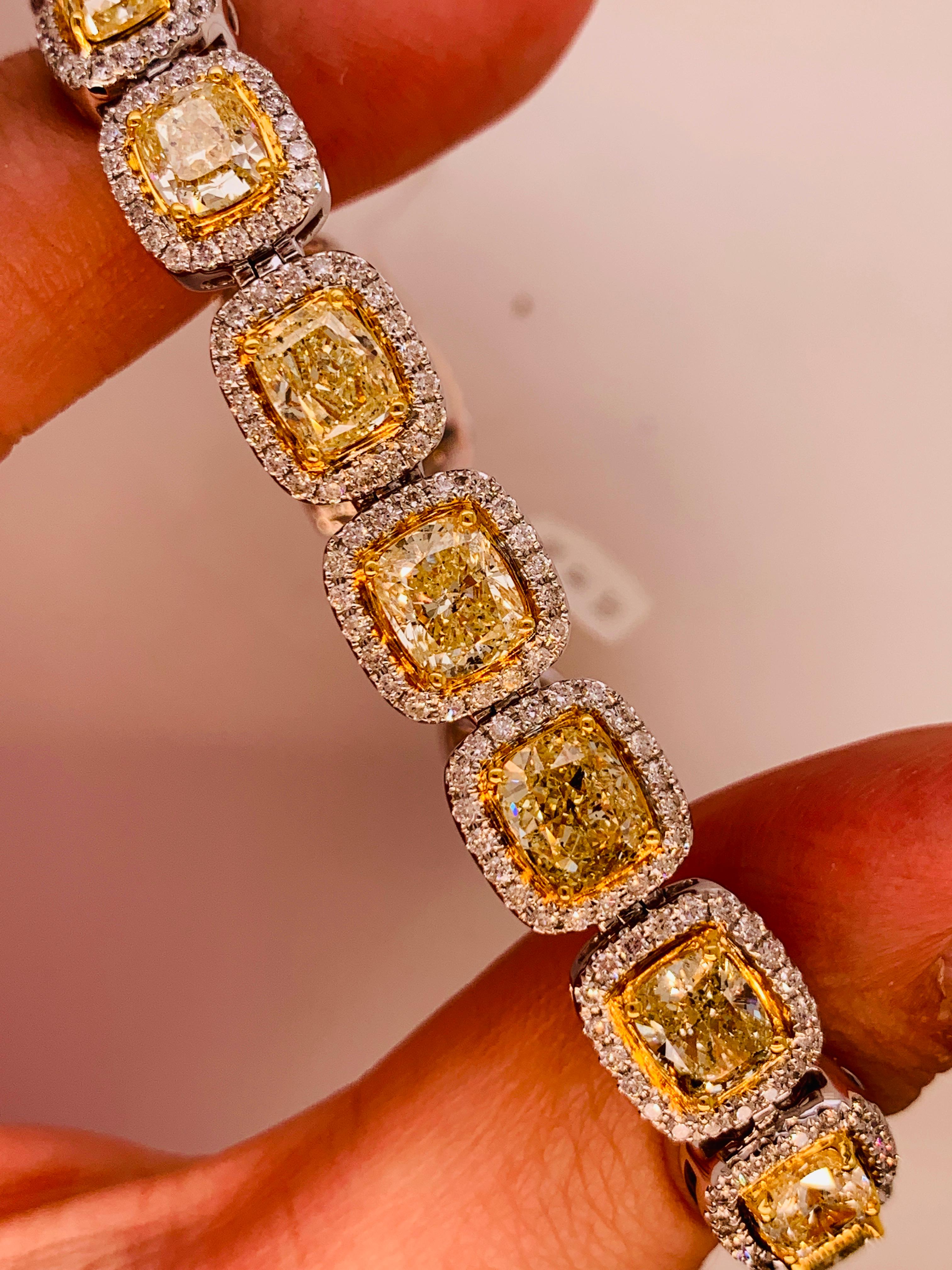 Elegant 18K white and yellow gold, yellow diamond bracelet features Eighteen cushion cut yellow diamonds, totaling 19.00 carats of Yellow diamonds, surrounded by 3.00 carats of white diamonds. Each yellow diamond is over one carat. 
7.5