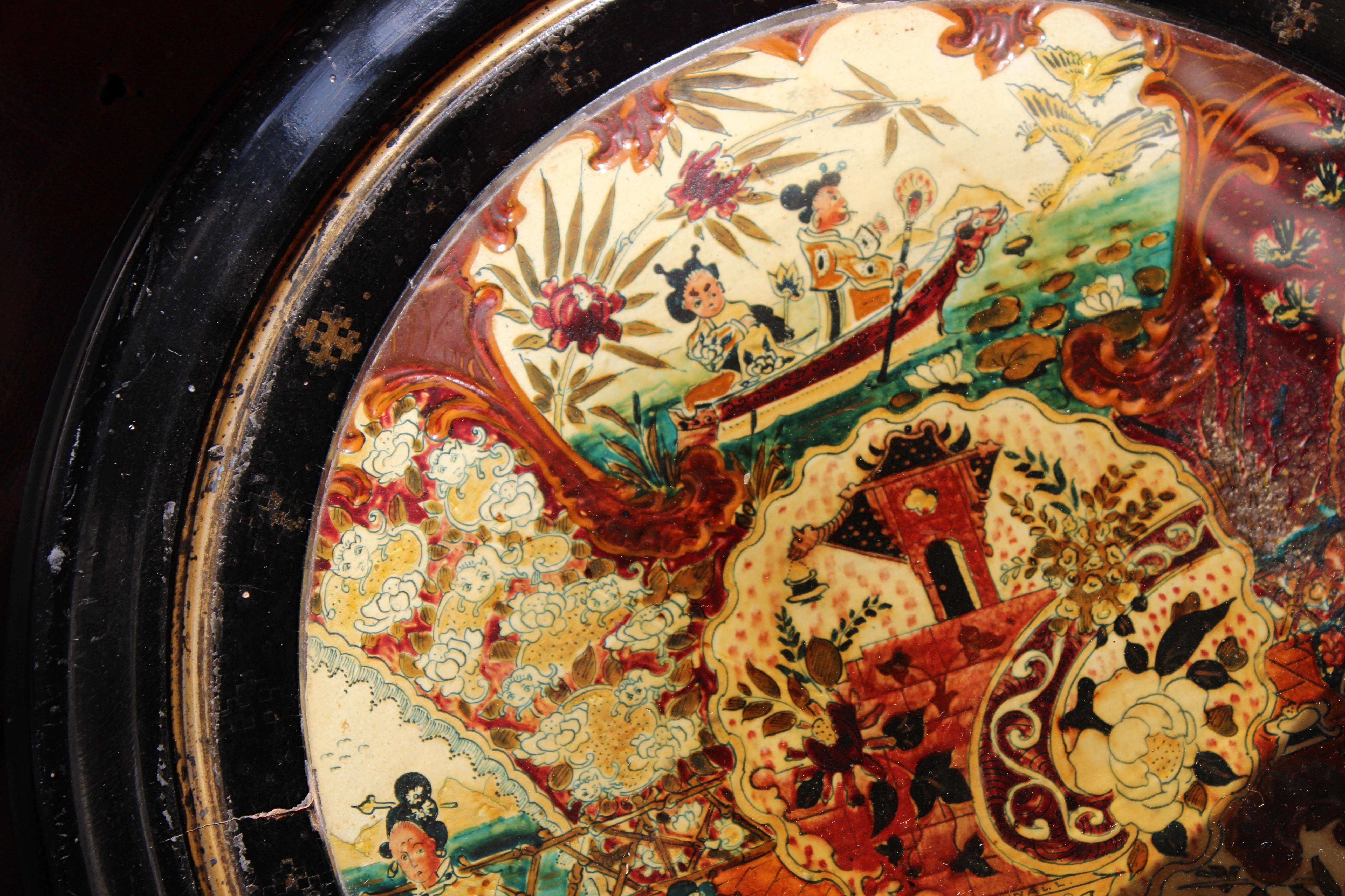 A very decorative Chinoiserie enamel plate, profusely decorated with typical exterior scenes, dragons, pagodas and oriental figures. 

House in a wonderful ebonised and gilt decorated frame, in very much country house condition.

Signed C Pownall