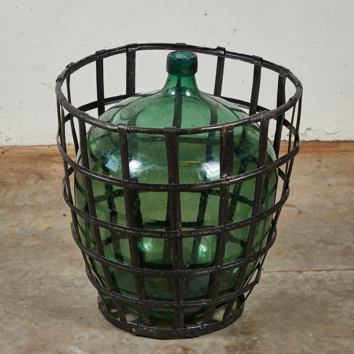 Industrial Early 20th Century French Metal Baskets with Bottles in Clear and Green Glass For Sale