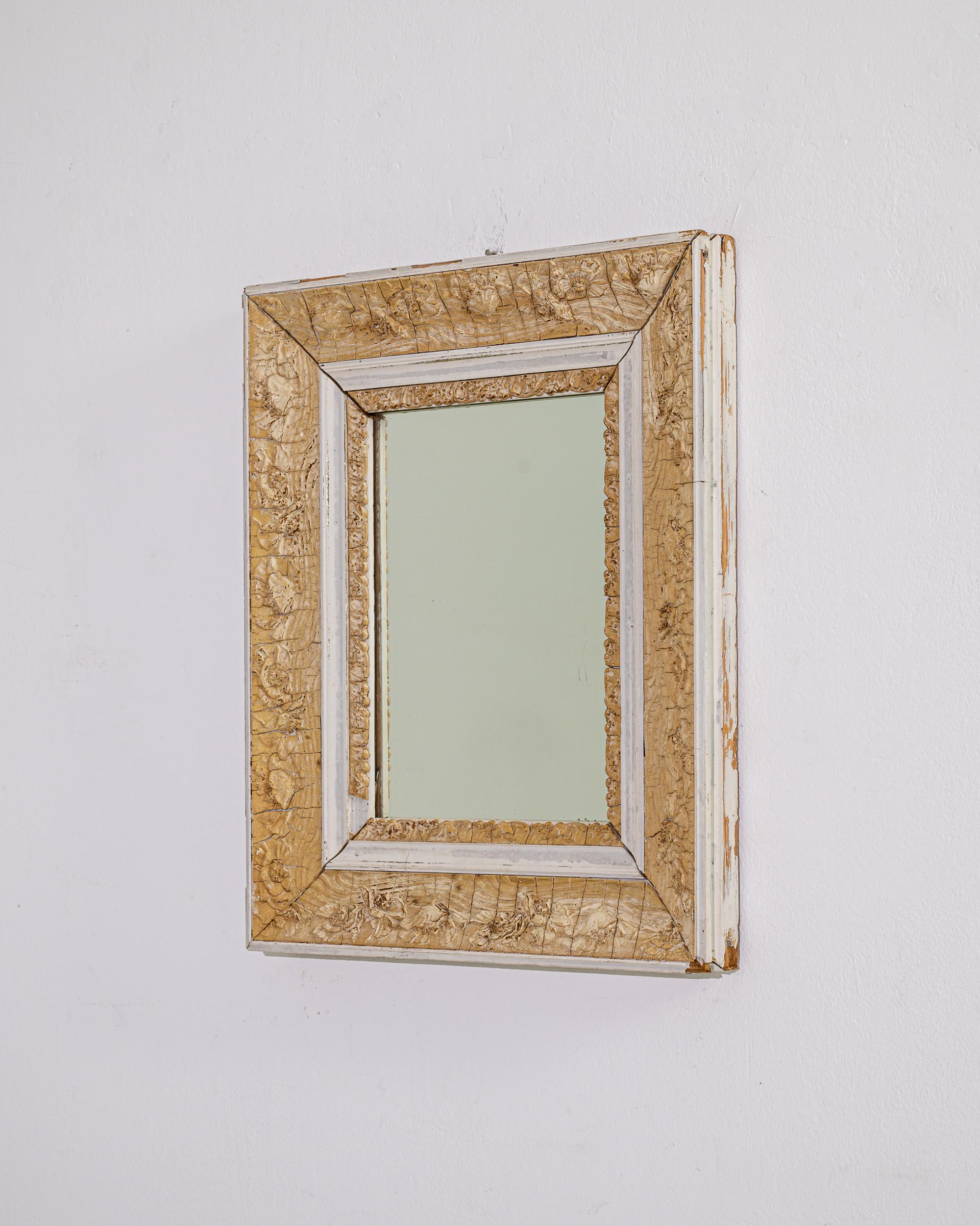 Elevate your décor with the timeless allure of this 1900 French Wooden Mirror. The antique charm emanates from the weathered patina that gracefully blankets the mirror, enhancing its vintage character. Adorned with delicate floral designs, the