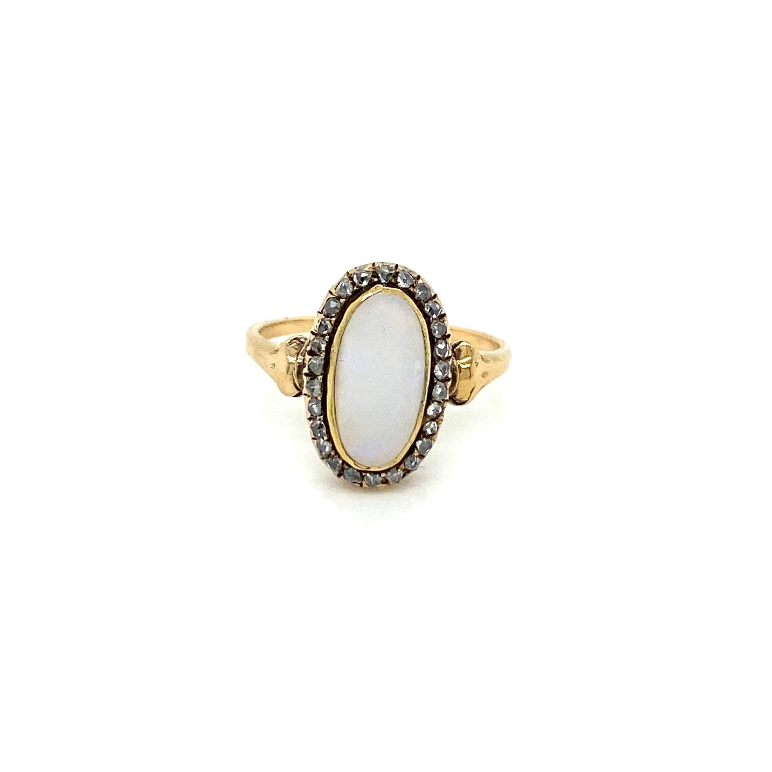 A beautiful Antique Opal and diamond ring, set in the centre with a Natural Opal cabochon and adorned by 0.30 carats Rose cut diamonds. Circa 1900'

CONDITION: Pre-owned - Excellent
METAL: 12k Gold
GEM STONE: Opal, Diamond 0.30 total carats 
RING