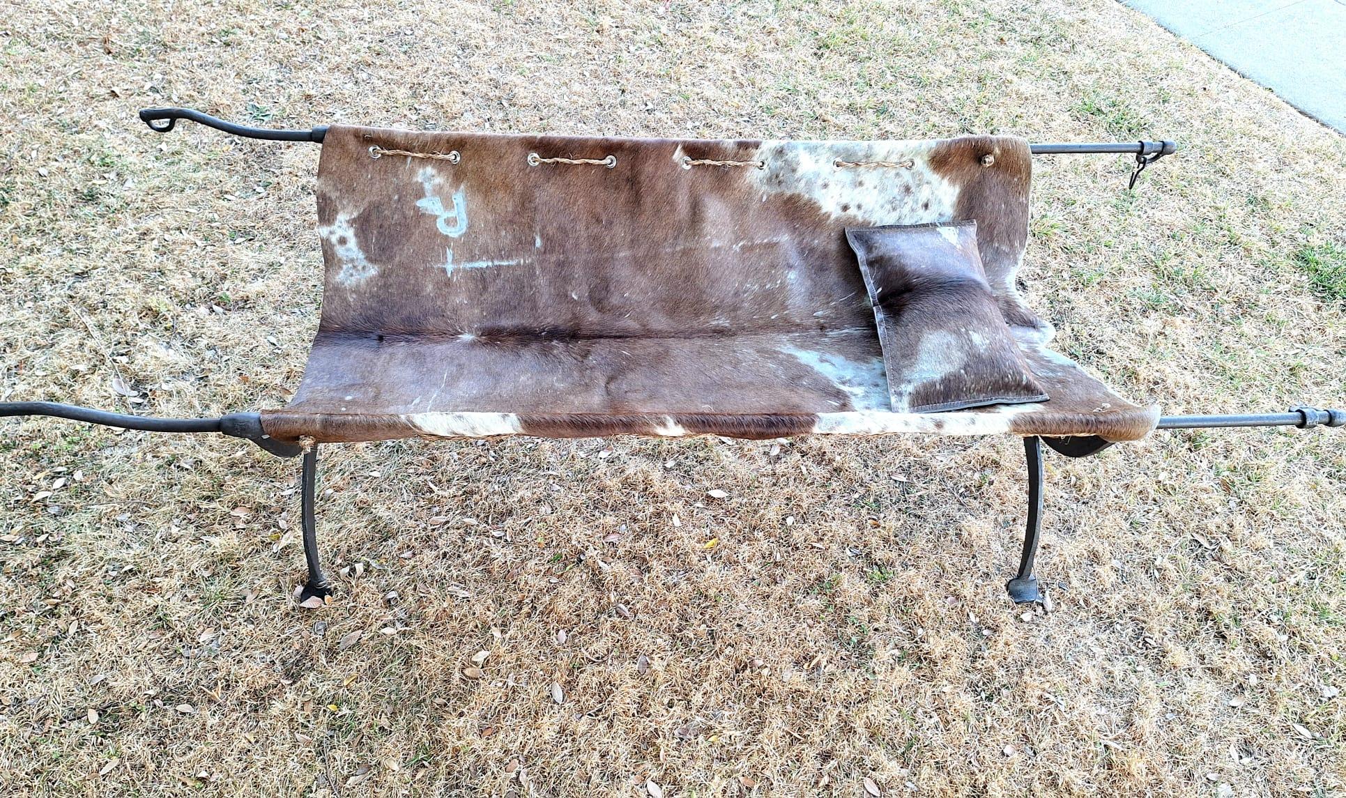 This type of furniture was typically used by military officers or travelers due to its portability and durability. The use of cowhide upholstery adds a rugged yet luxurious touch, indicative of the practical elegance common in such pieces. The metal