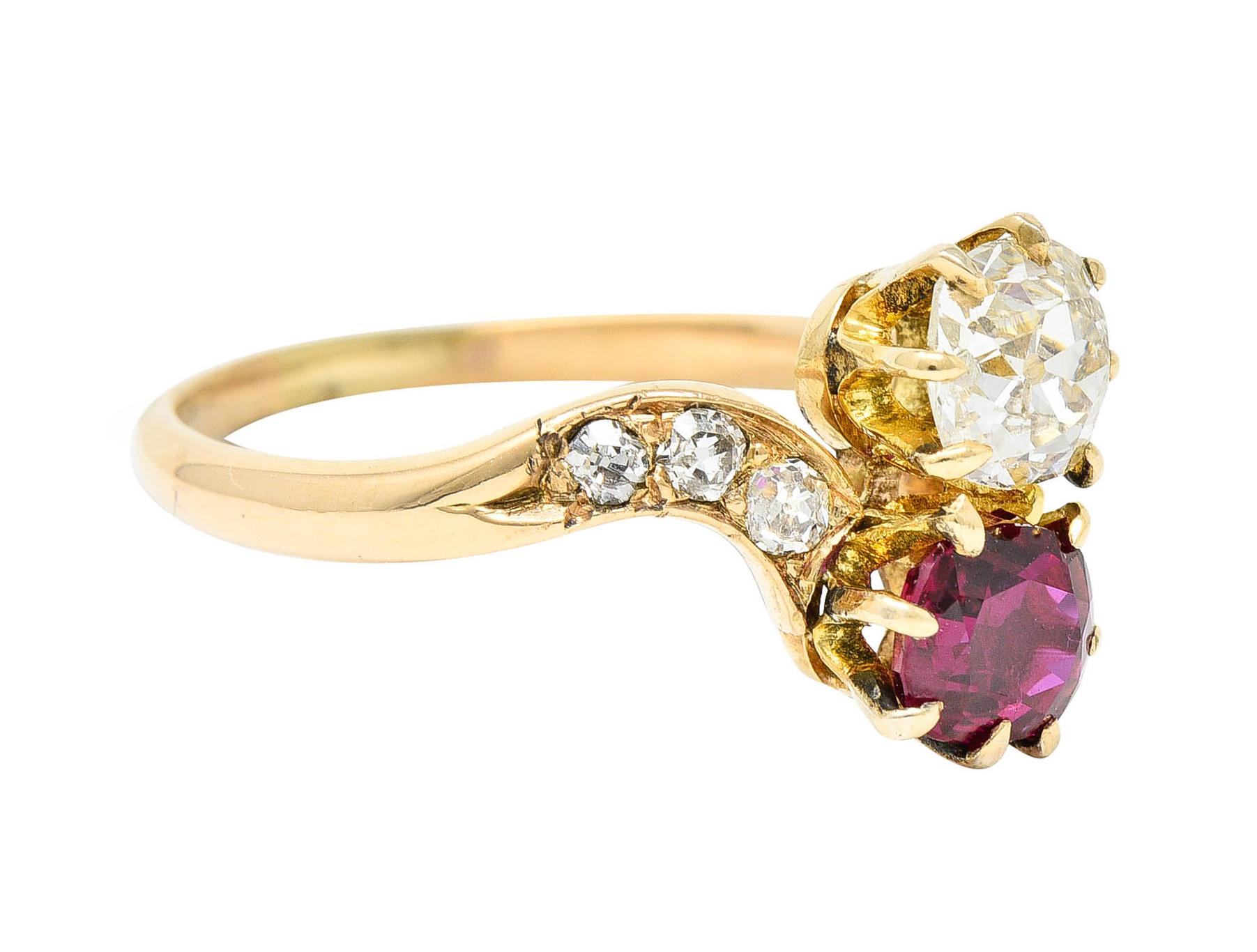 Bypass style ring featuring a double stone motif is the Toi et Moi style - French to mean 'You and Me'

With an old mine cut diamond weighing approximately 0.55 carat with K color and SI2 clarity

With a cushion cut ruby weighing approximately 0.50