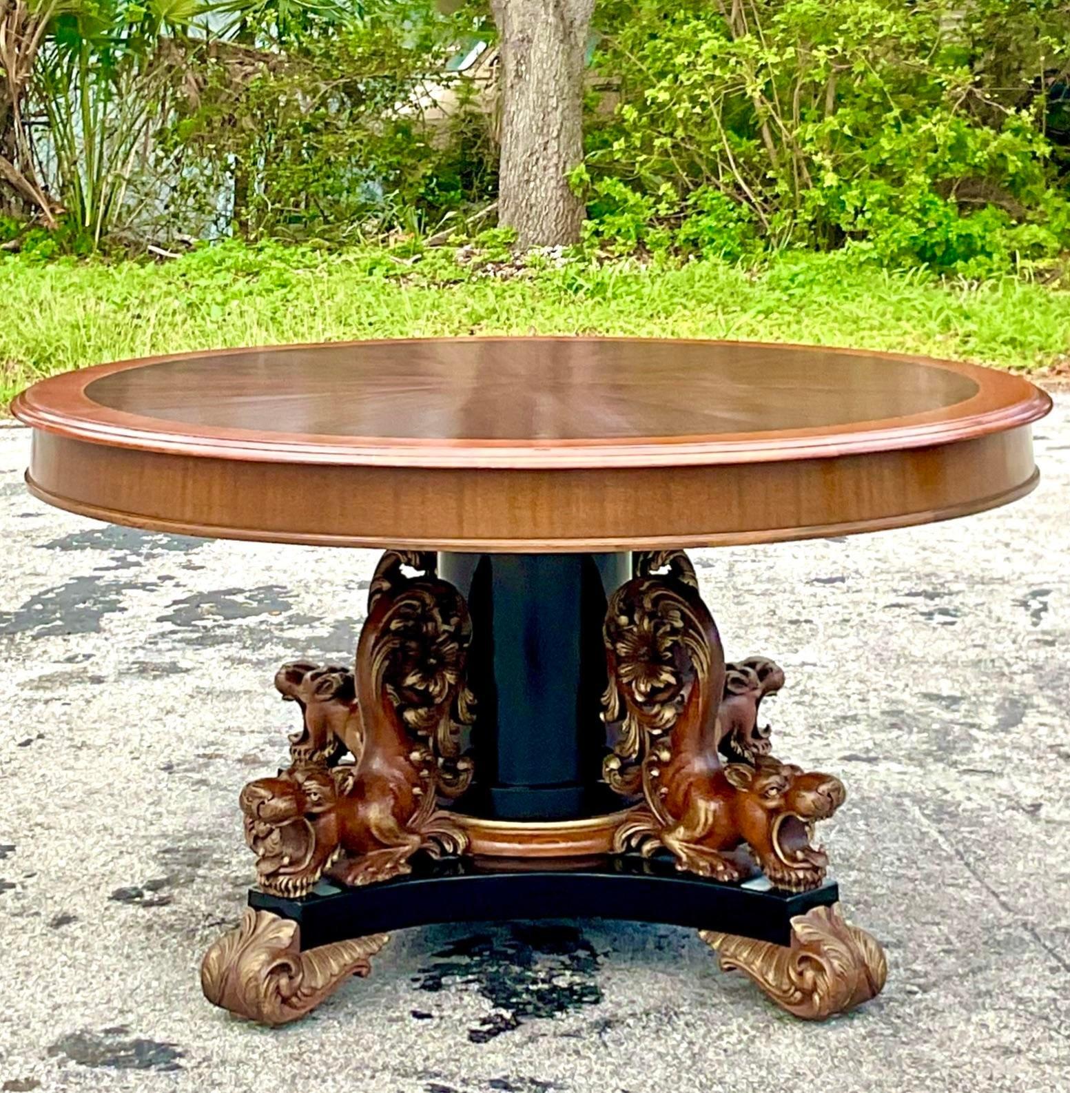 A stunning vintage late 19th Century Regency dining table. Made by the Williamsport J. K. Rishel group and tagged on the bottom. Beautiful hand carved detail on four lions that are attached to the pedestal. Acquired from a Palm Beach estate