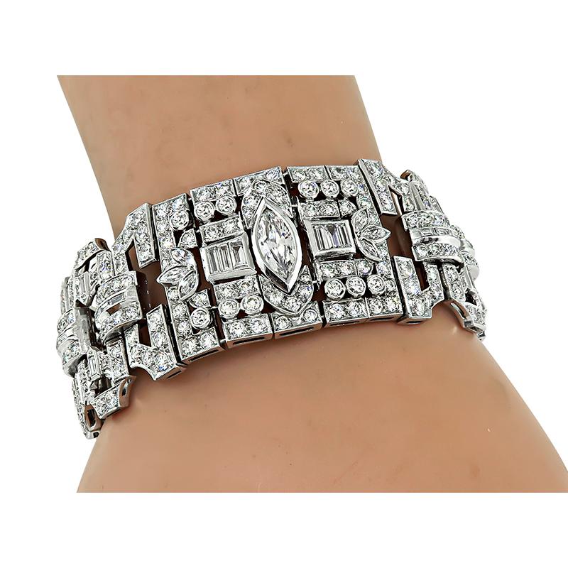 This is a stunning platinum bracelet. The bracelet features sparkling marquise, baguette and European cut diamonds that weigh approximately 19.00ct. The color of these diamonds is G with VS clarity. The bracelet measures 26.5mm in width and 7 1/4