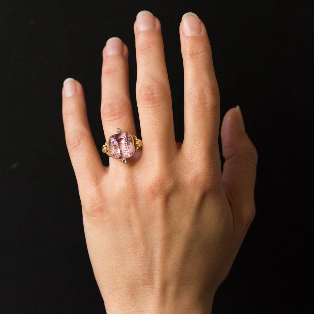 Ring in 18 karats yellow gold.
This splendid antique ring is millegrains closed set of an important cushion-cut amethyst surmounted on both sides of 2 x 1 rosecut diamond also millegrains closed set. On both sides, on the departure of the ring, 2 x