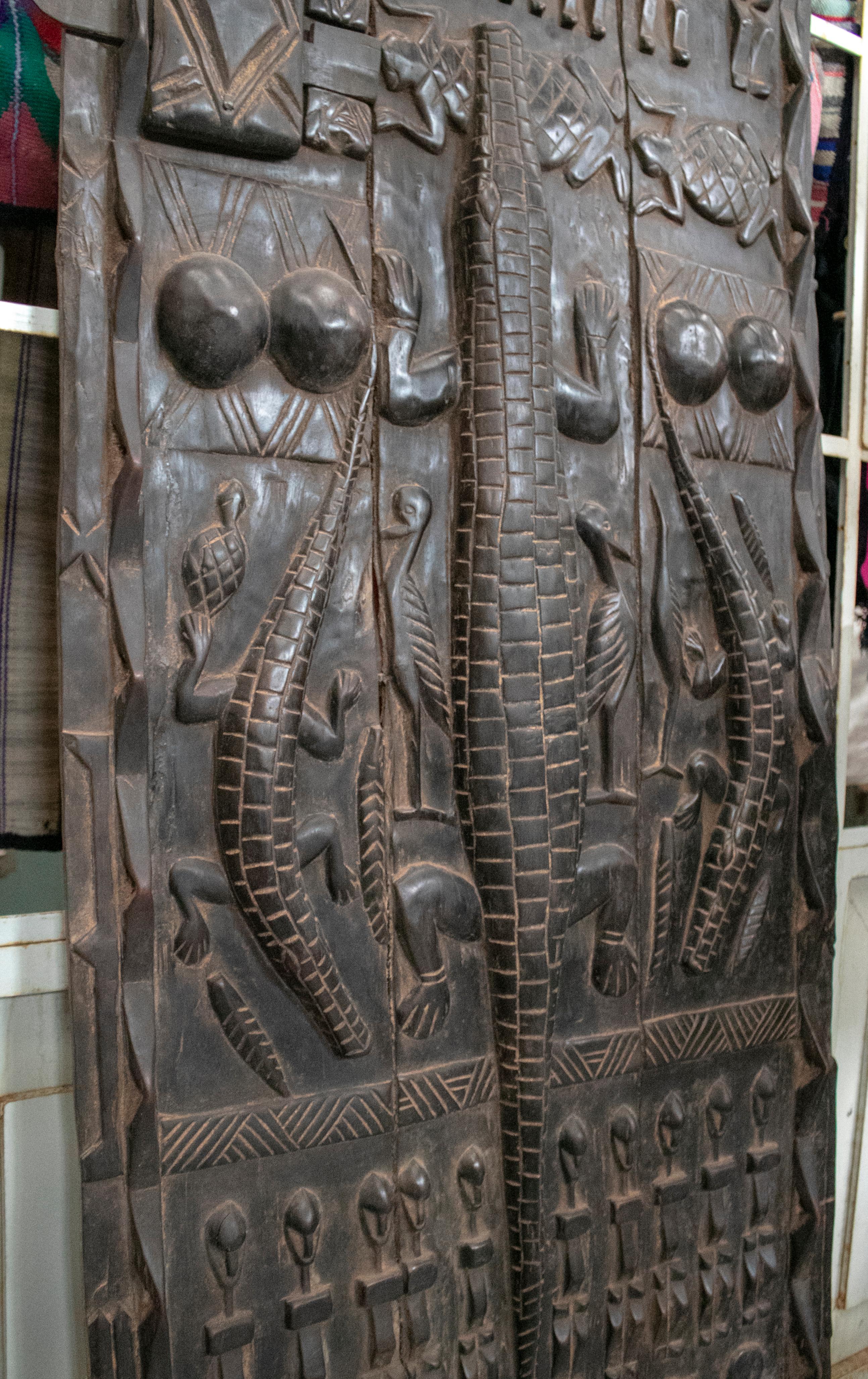 20th Century 1900s African Wooden Door with Hand Carved Ethnic Human and Animal Relief
