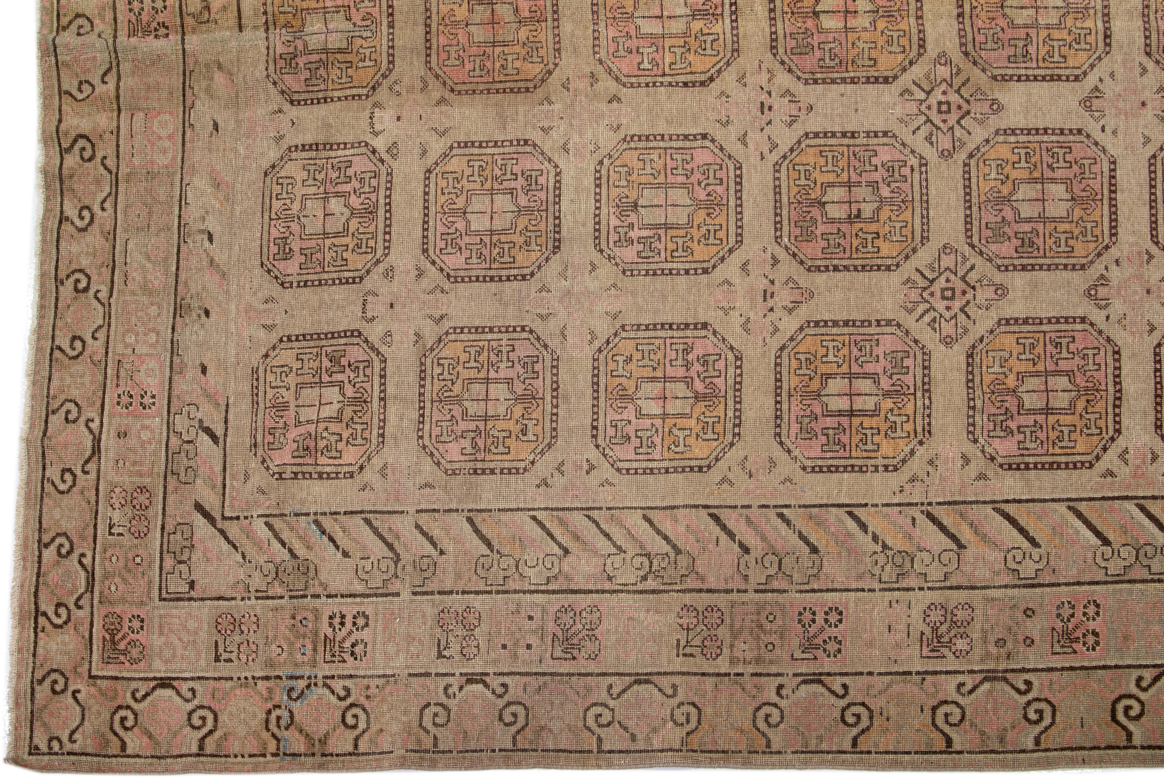 East Turkestani 1900s Antique Brown Handmade Khotan Wool Rug with Geometric Pattern For Sale