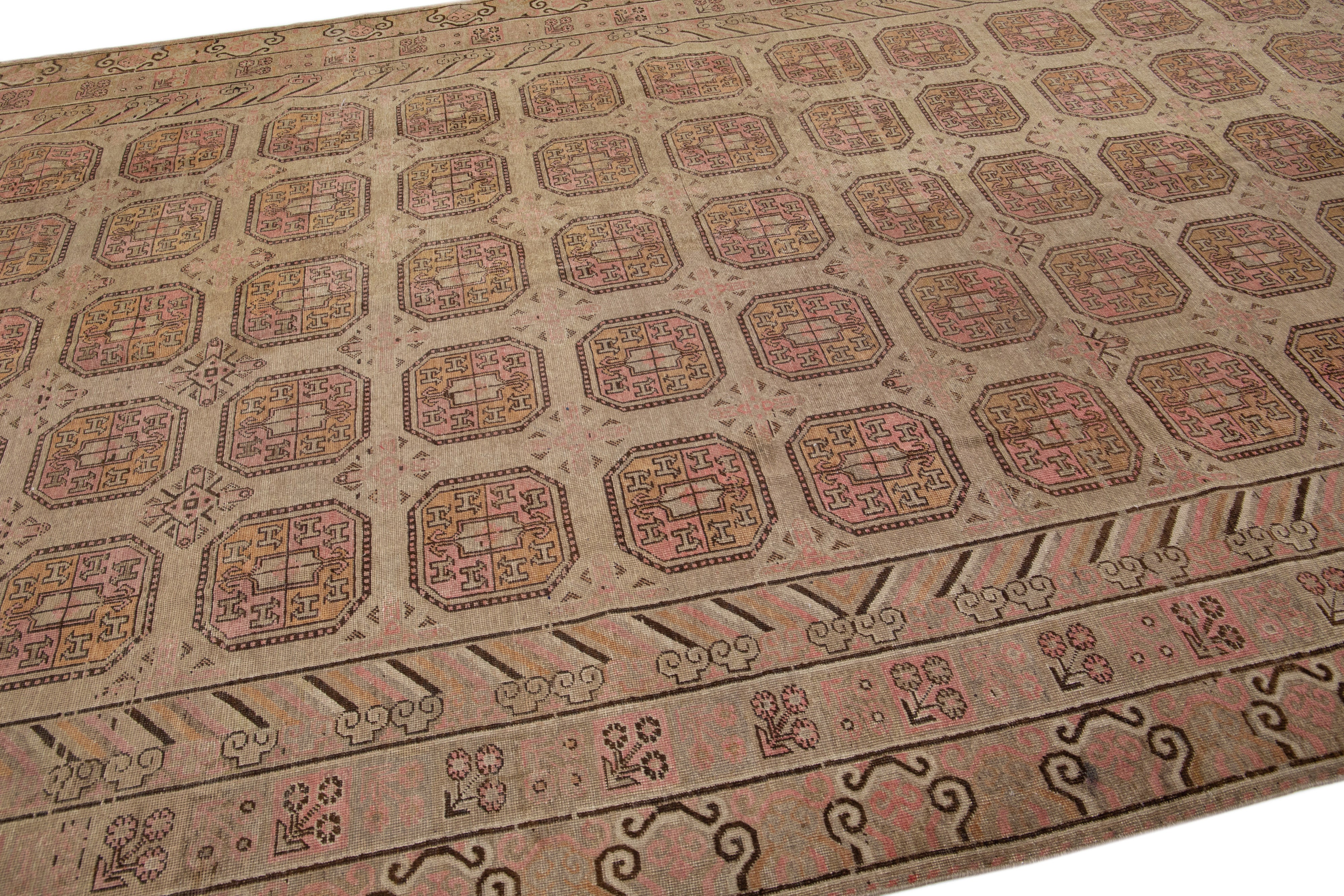Hand-Knotted 1900s Antique Brown Handmade Khotan Wool Rug with Geometric Pattern For Sale