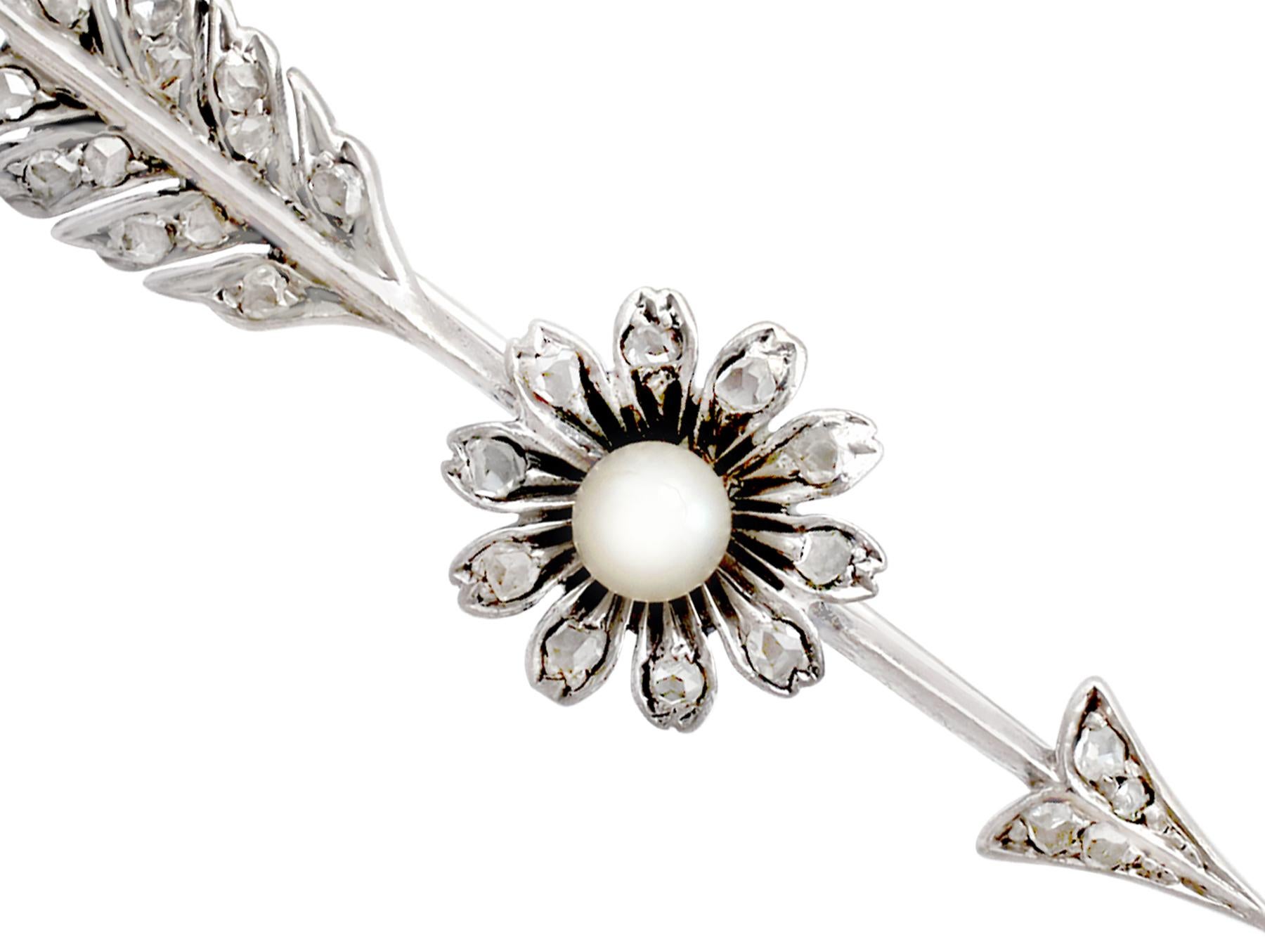 A fine and impressive 0.28 Ct diamond and seed pearl, 9kt white gold and silver set arrow brooch; part of our diverse antique jewelry and estate jewelry collections.

This fine and impressive pearl and diamond arrow brooch has been crafted in 9k