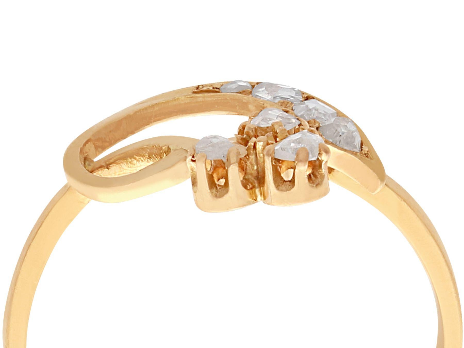 A fine antique 0.25 carat diamond and 18 karat yellow gold dress ring; part of our antique jewelry and estate jewelry collections

This fine antique dress ring has been crafted in 18k yellow gold.

The intertwined, stylised leaf and bud design, low