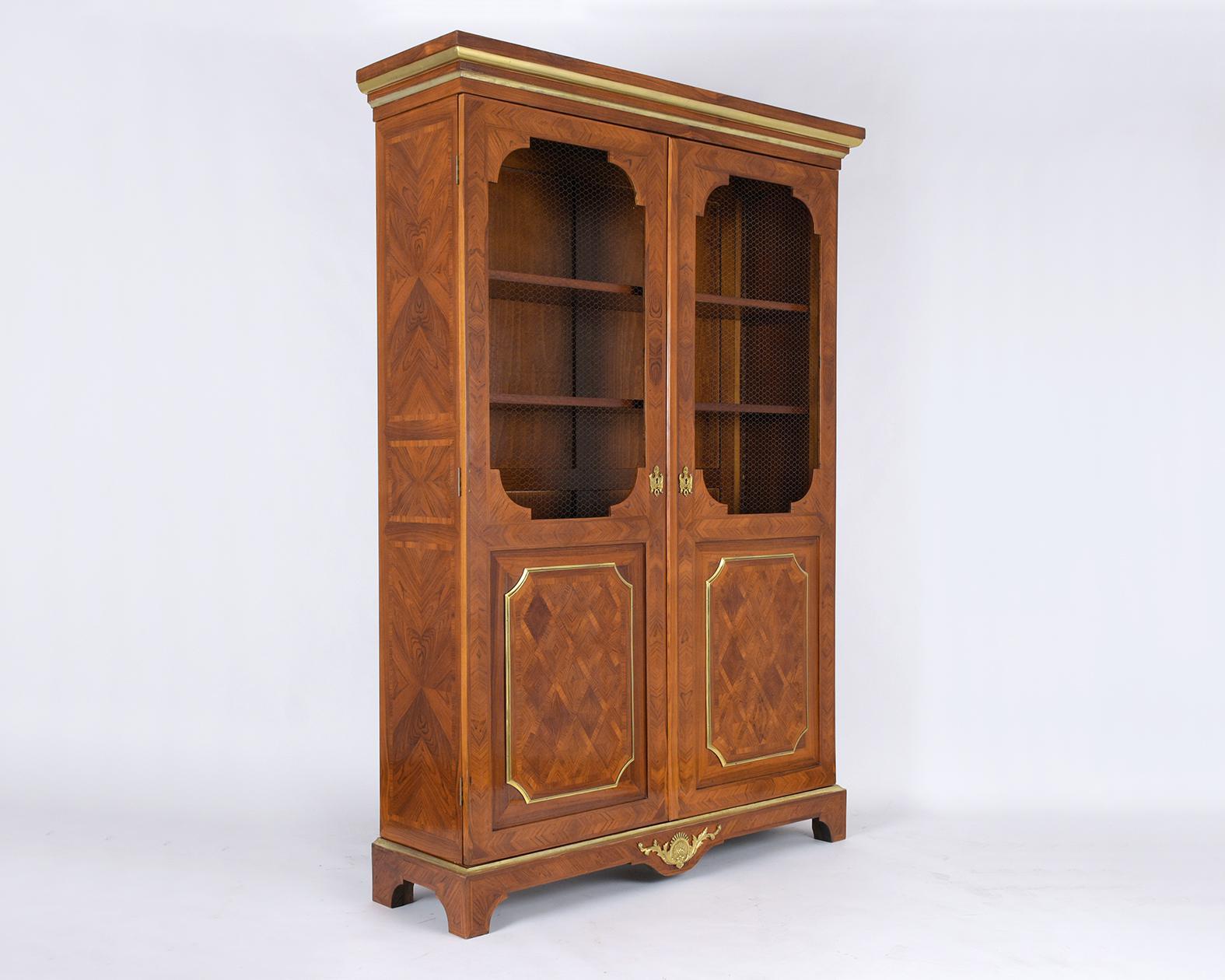 Step back into the grandeur of the 1900s with our exquisite antique French Louis XVI-style walnut bookcase, a true masterpiece showcasing the pinnacle of traditional craftsmanship. Handcrafted with care and precision, this vintage piece is