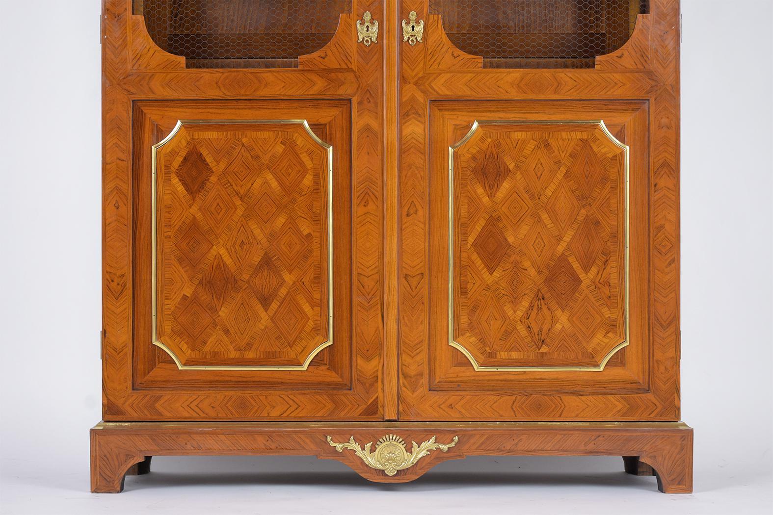 Early 20th Century Antique French Louis XVI-Style Walnut Bookcase with Marquetry and Brass Details For Sale