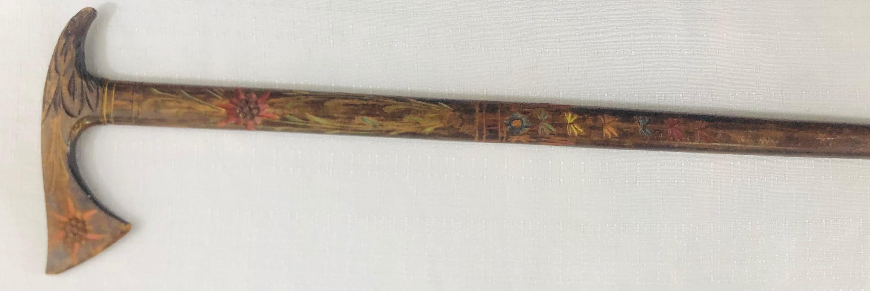 An early 20th century hand carved wood men's cane. The cane features beautiful hand carving of flowers painted in multiple colors. The name of what it seems to be the original owner is carved on the handle. 

Measures: 37