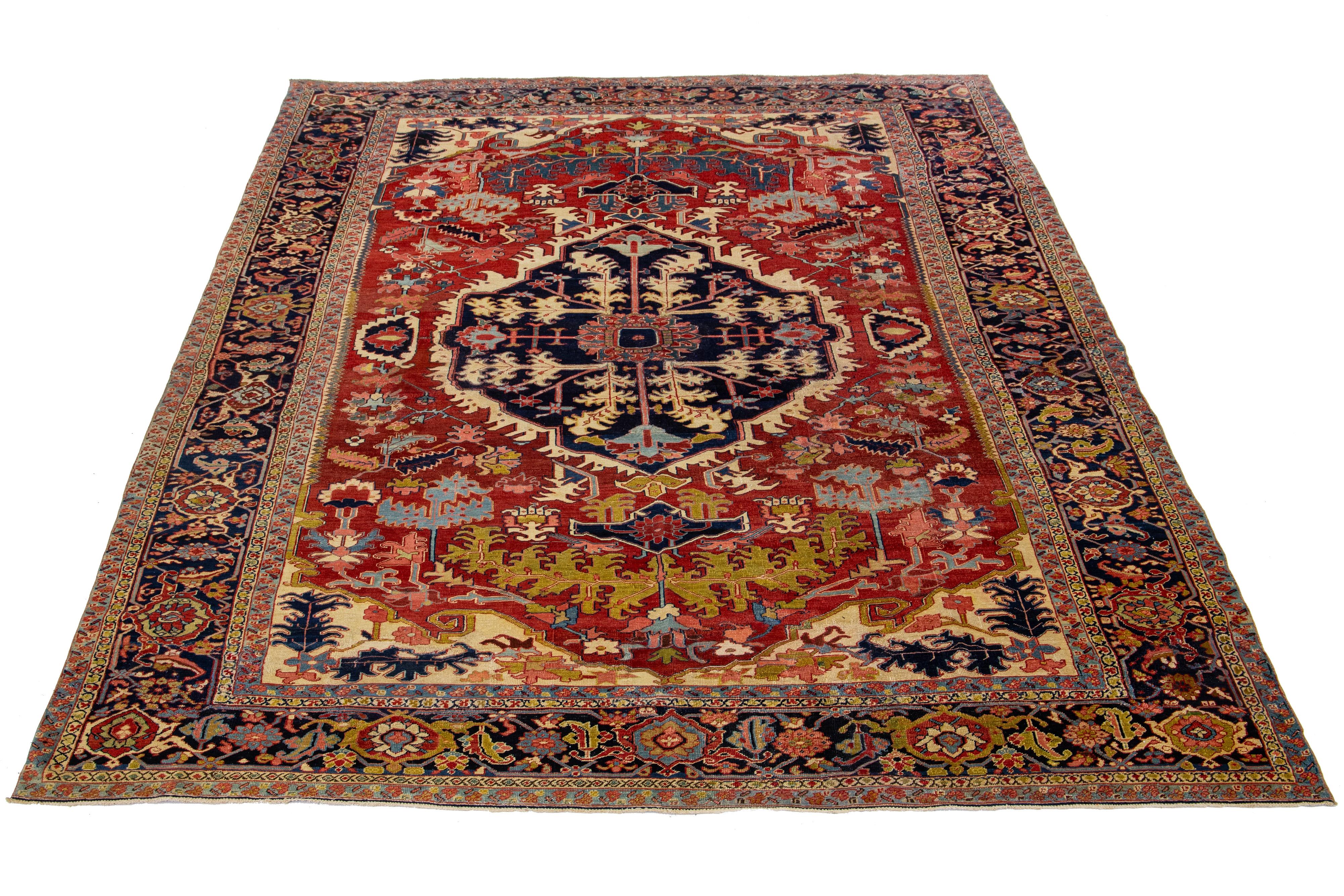 This antique Persian Heriz rug is made of hand-knotted wool. The red field showcases a captivating medallion pattern adorned with multiple shades of colors.

This rug measures 9'3