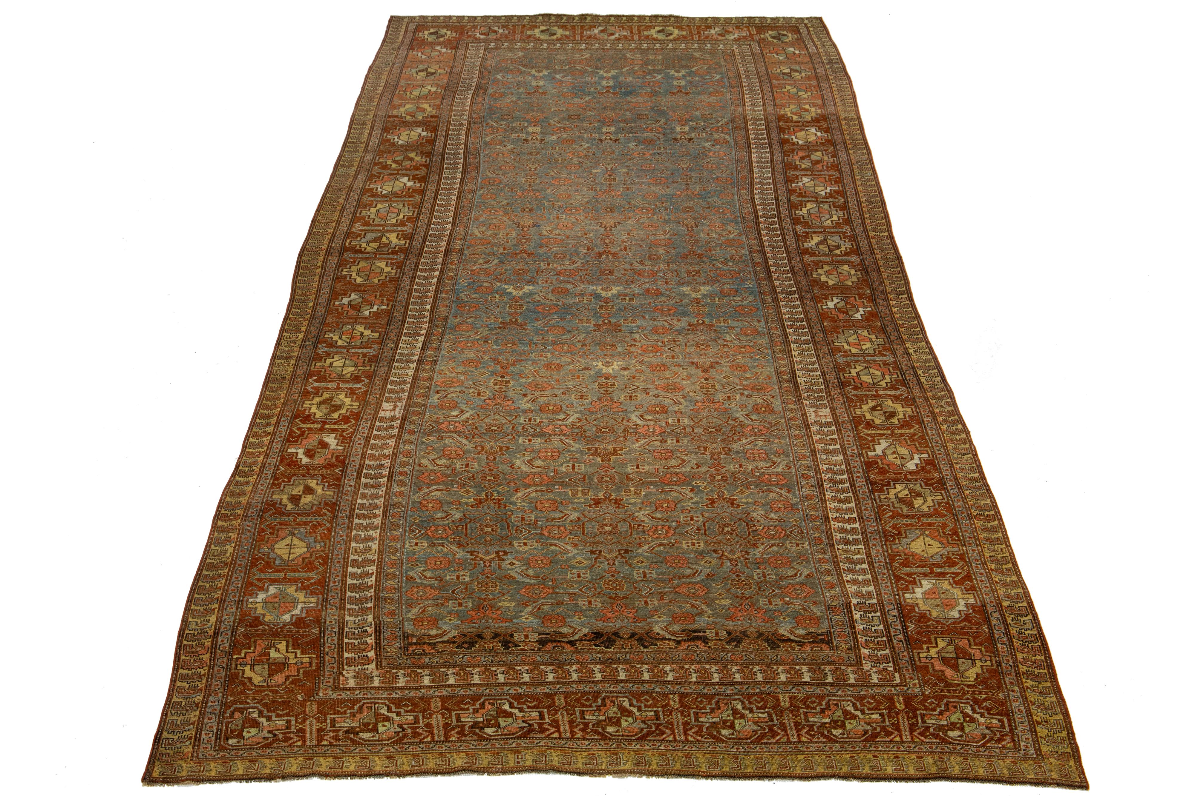 Beautiful antique Bidjar hand-knotted wool runner with a blue color field. This Bidjar rug has a designed rusted frame with beige and yellow accents in a gorgeous all-over geometric design.

This rug measures 7'3