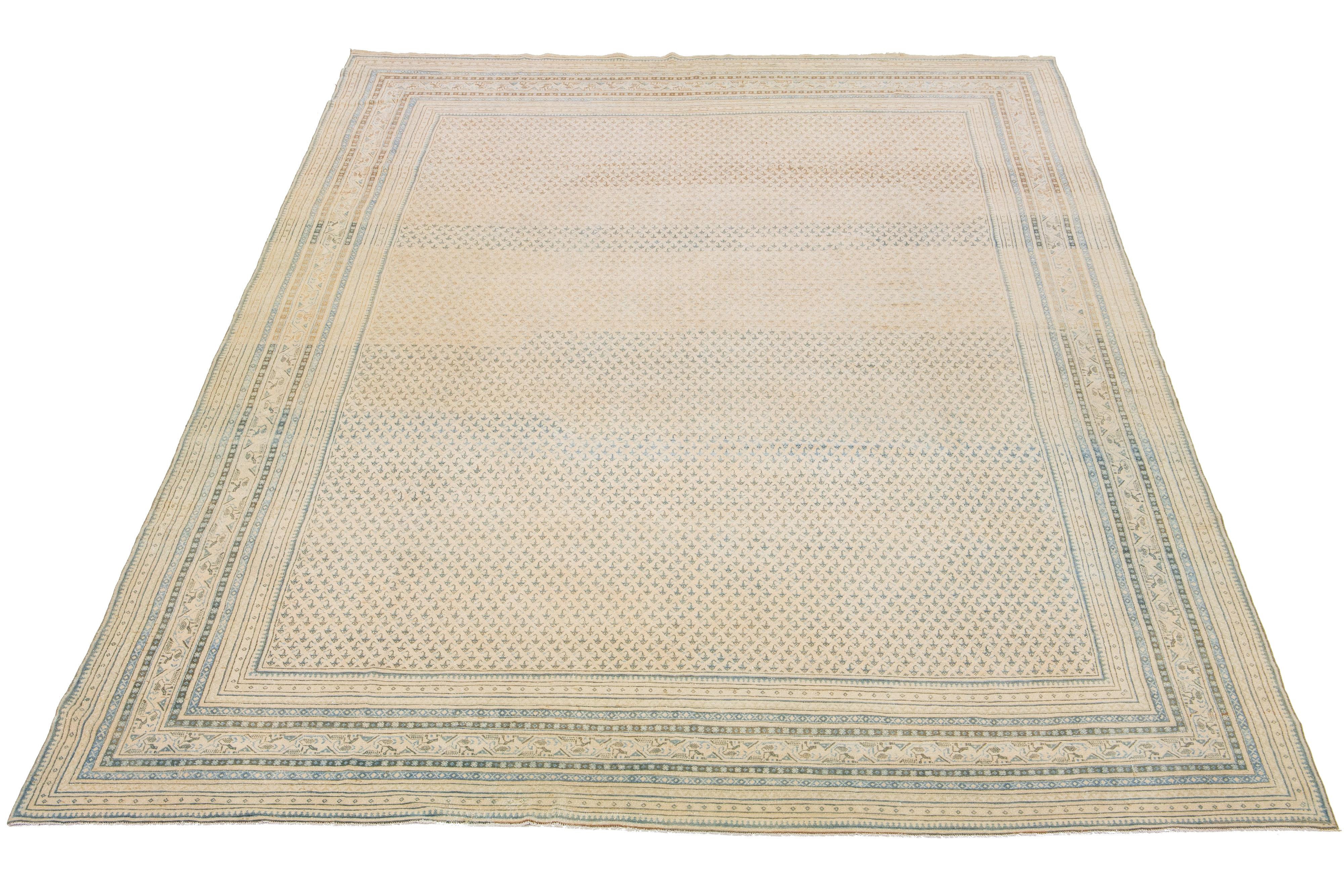 This Persian Malayer rug is an antique piece of hand-knotted wool. It features a beautiful beige field adorned with blue highlights, all arranged in a timeless classical pattern.

This rug measures 10'11