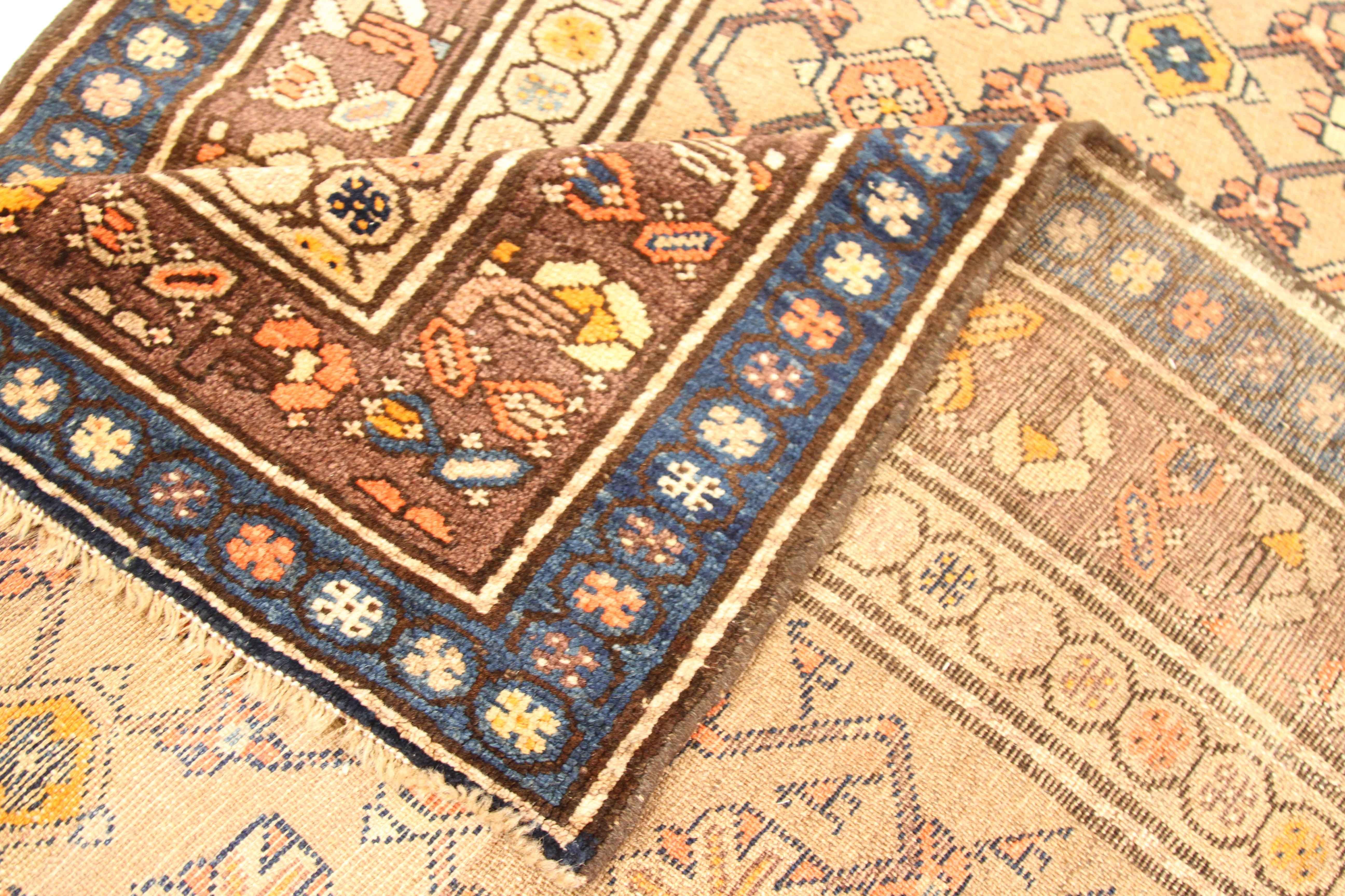 Antique Persian runner rug handwoven from the finest sheep’s wool and colored with all-natural vegetable dyes that are safe for humans and pets. It’s a traditional Malayer design featuring blue, orange, and red floral and geometric details over a