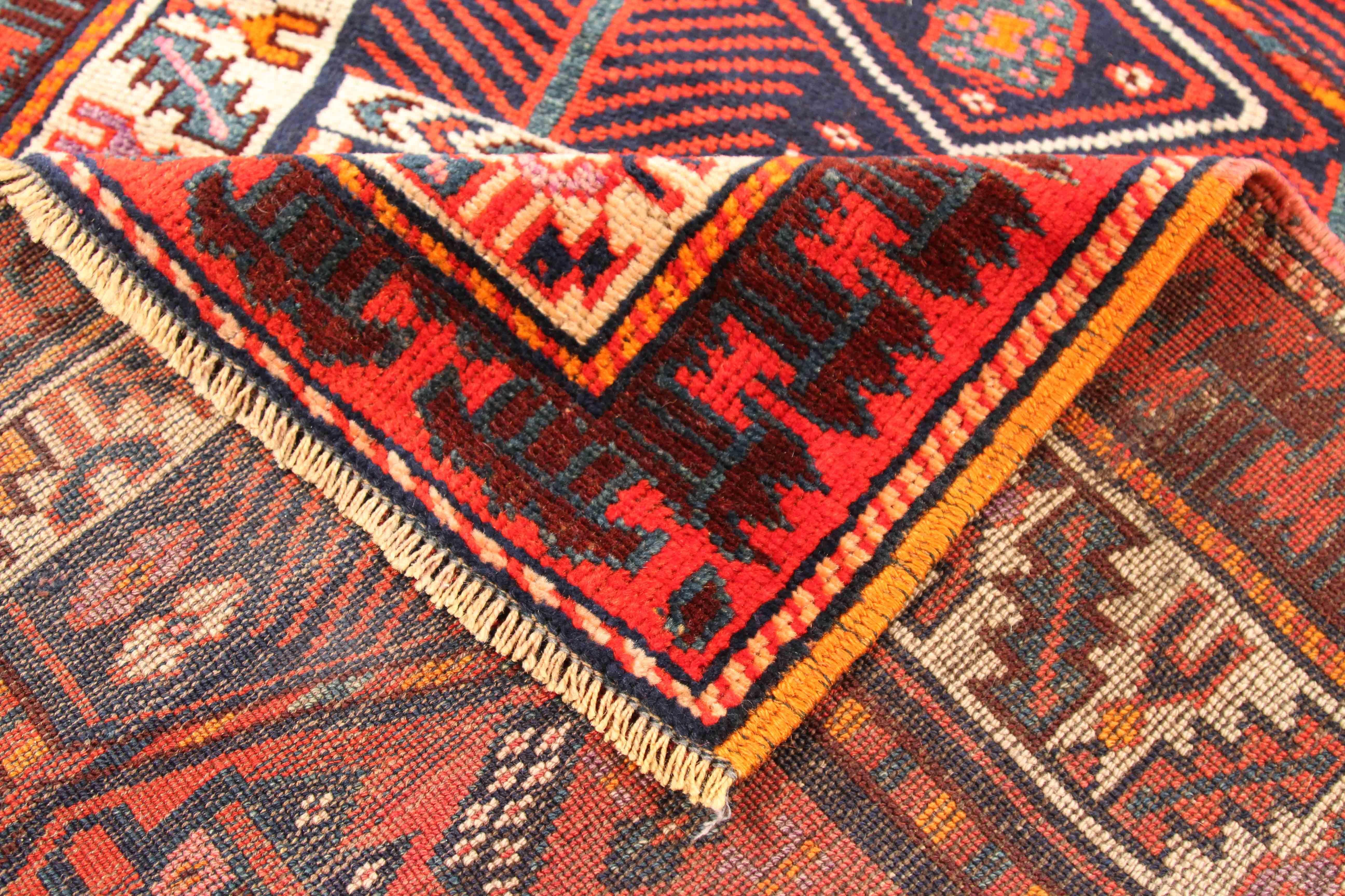 Antique Azerbaijan area rug with extended length. Its dimension runs 2’10” x 23’3” which works great for long entryways and hallways. It features a tribal design consisting of geometric patterns in traditional colors such as red, black, and orange.