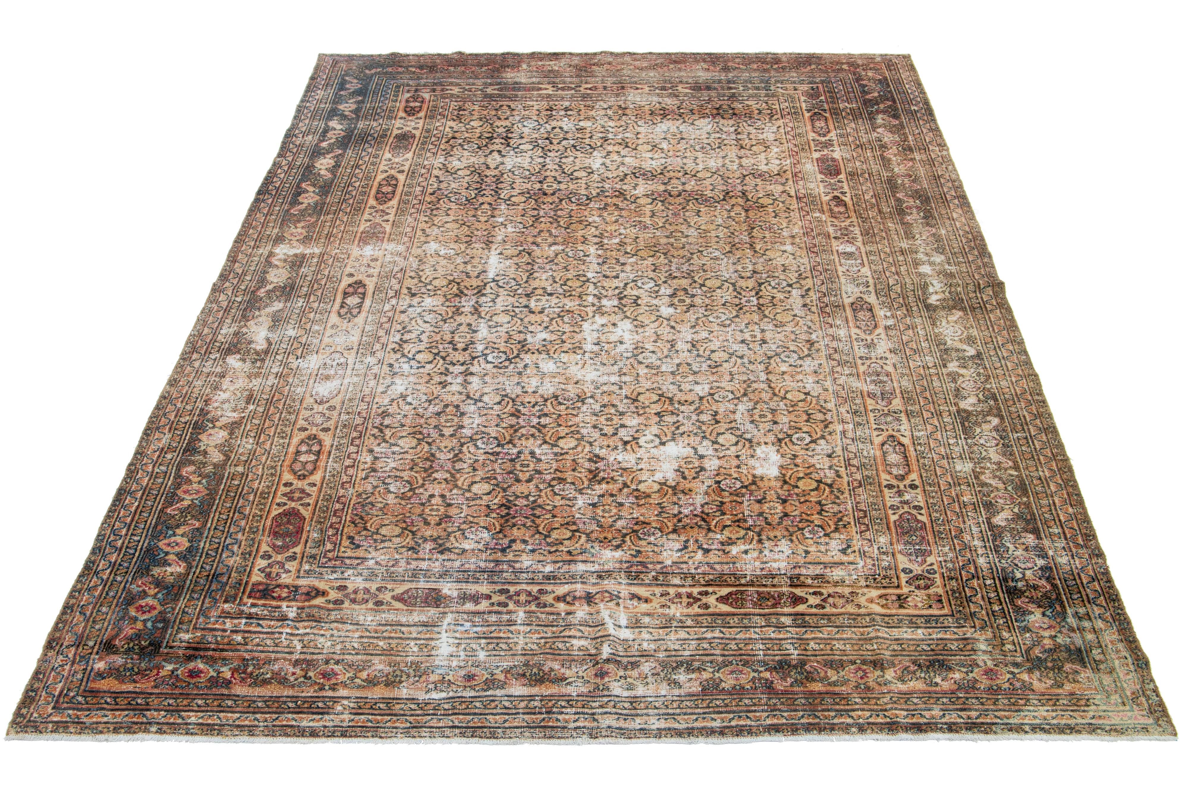 A Persian Tabriz wool rug showcases a meticulously crafted, timeless floral pattern. The design is elevated through the use of contrasting colors such as rust, brown, red, and blue within the field.

This rug measures 7'2