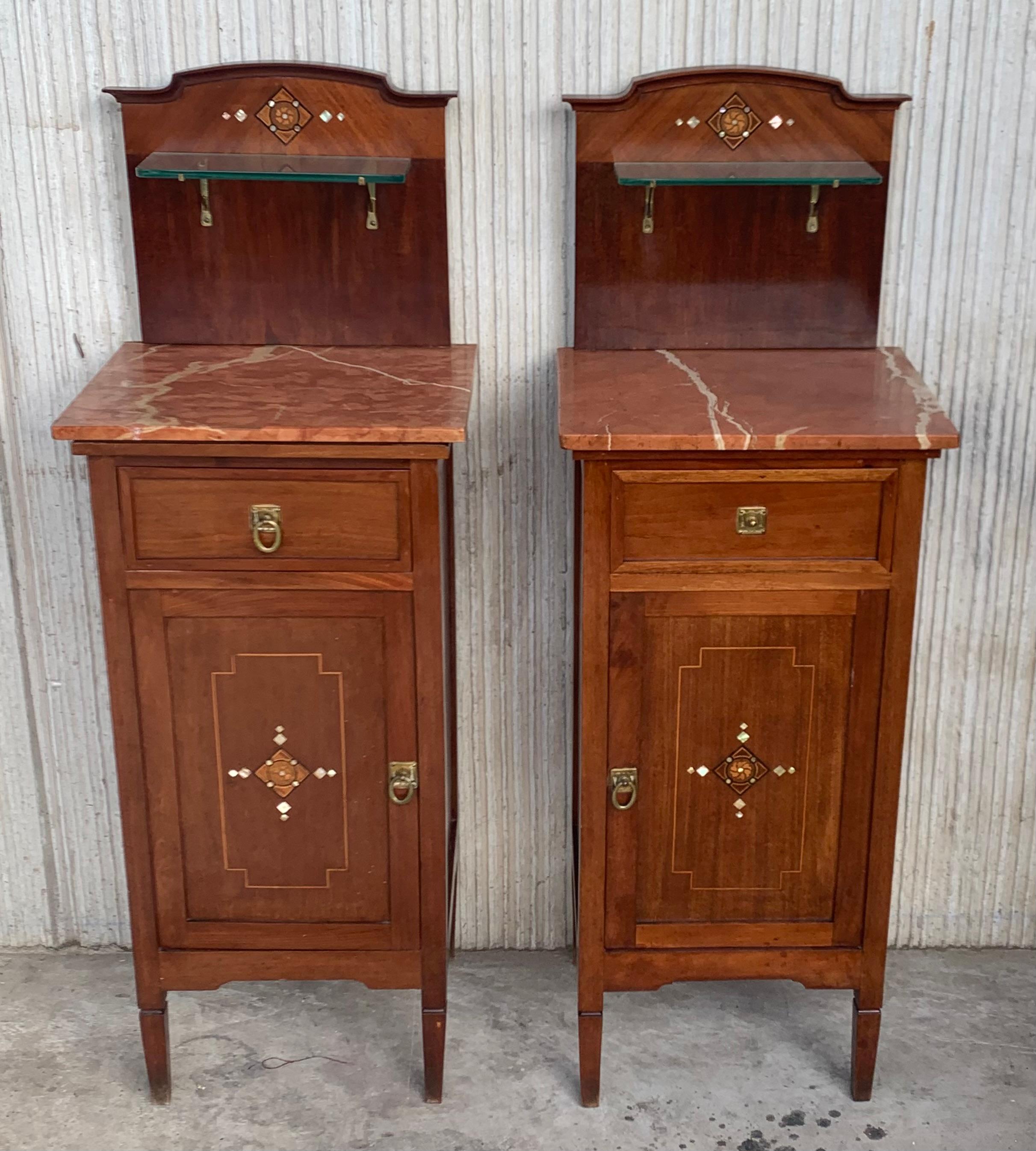 Late 19th century Art Nouveau pair of nightstands with marquetry inlays in walnut, bronze handles, restored and polished to wax.
Measures: Height to the glass shelve 42.12in
Height to the table 32.48in.