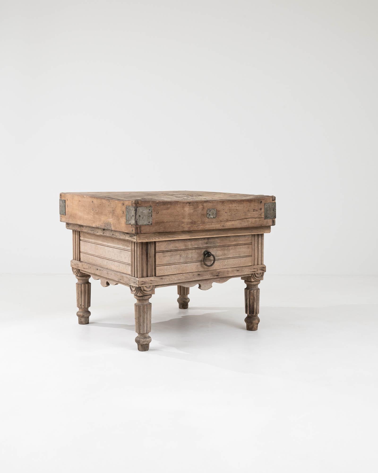 A captivating fusion of functionality and elegance, this work table hails from early 20th-century Belgium. The sturdy tabletop is constructed from separate wooden blocks, expertly assembled to provide the additional support traditionally required by