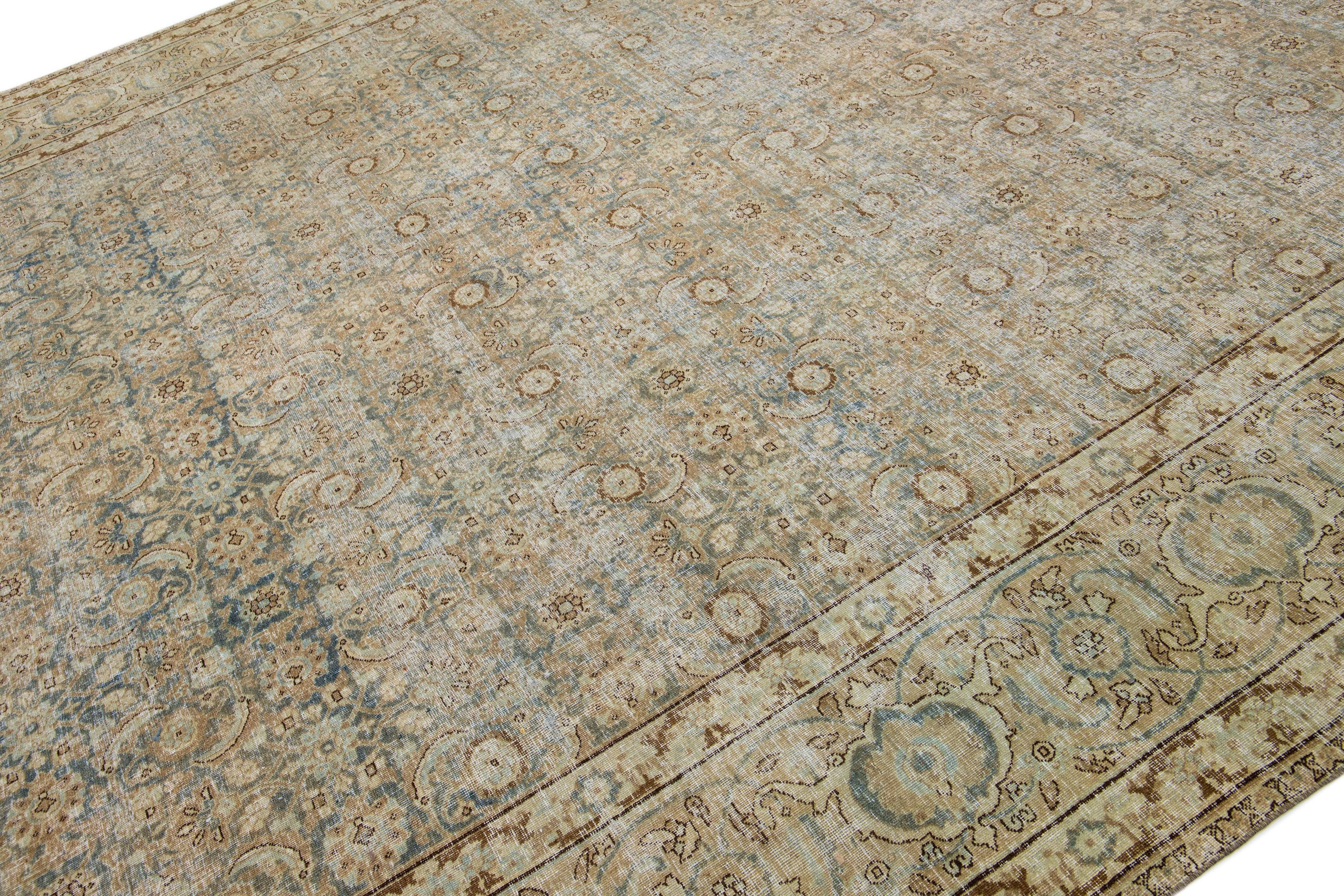 Noué à la main Tapis persan ancien bleu des années 1900, conçu par Tabriz, avec motif floral en vente